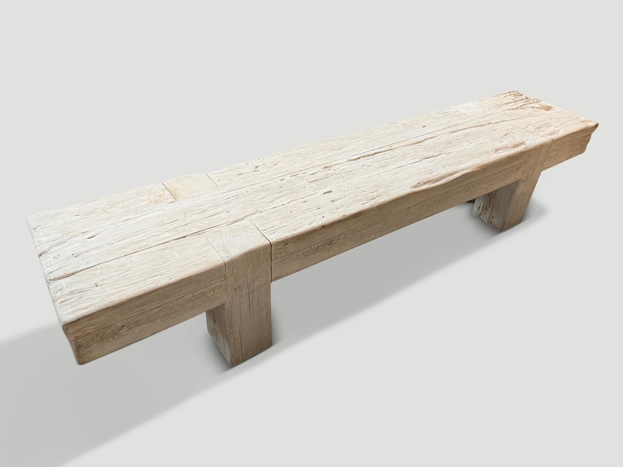 Impressive century old six inch thick logs are joined together to form this unique coffee table or bench. The teak wood is first bleached and finally a light white wash applied revealing the beautiful wood grain. The minimalist legs are recessed