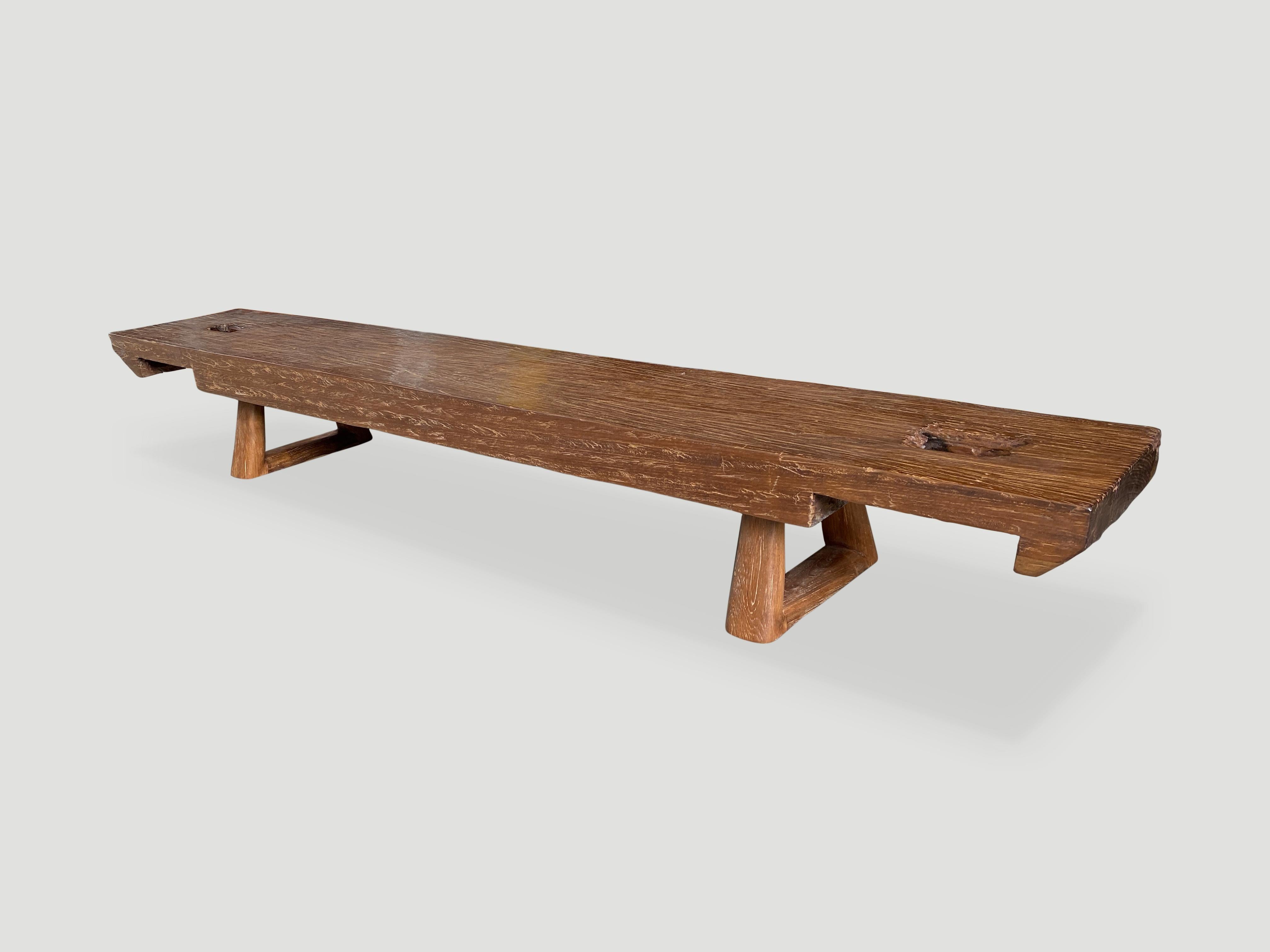 Beautiful single carved teak bench with a five inch thick top. Added triangle style base and cut out ends. A natural oil finish reveals the beautiful wood grain. We have a pair. The price and images reflect the one shown.

Own an Andrianna