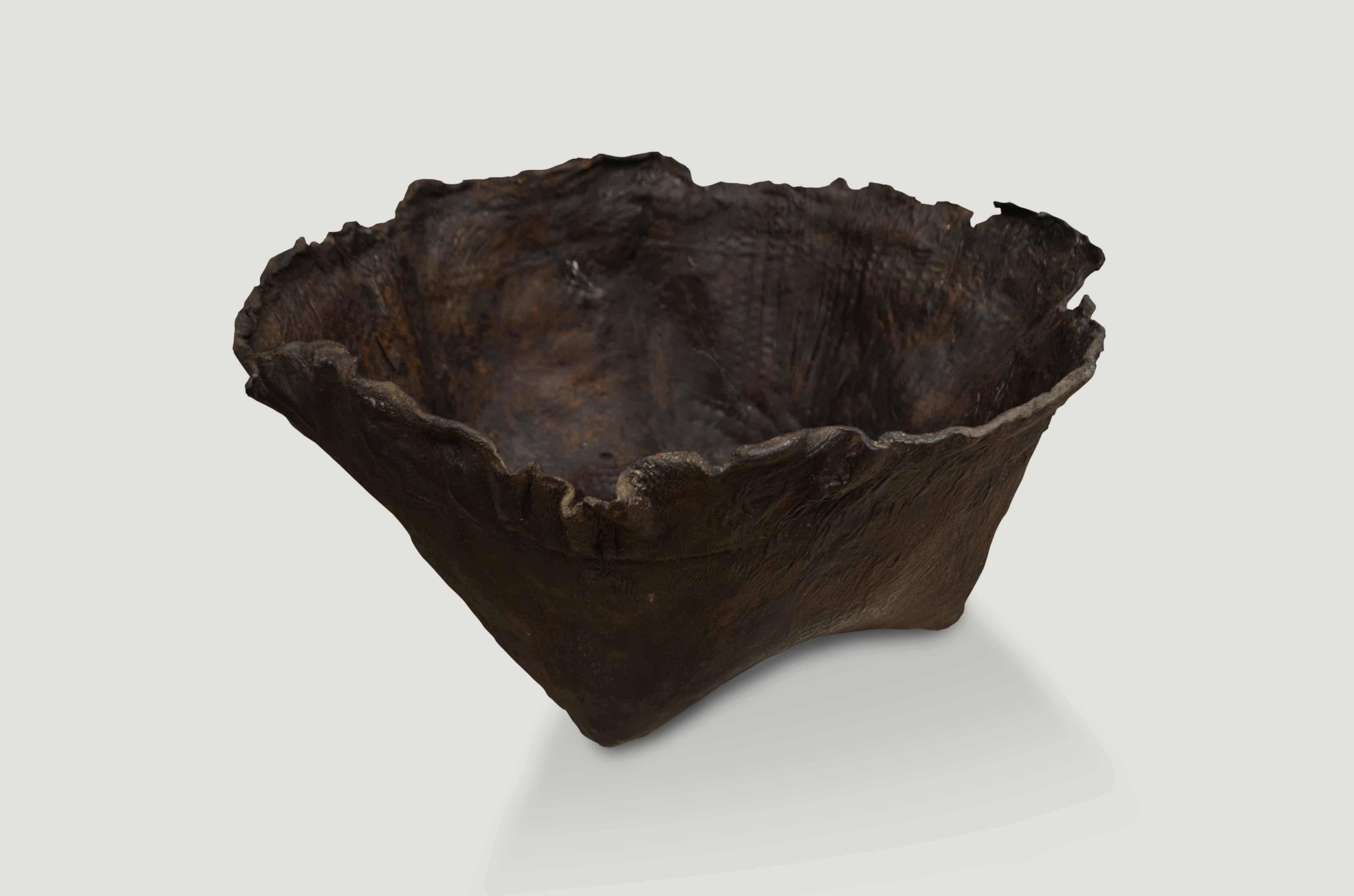 Antique container from Borneo made from aged buffalo hide and formed to produce a bowl. Beautiful espresso patina and natural organic rim. Great for holding magazines, towels, firewood, etc. We have a collection. All unique.

This container was