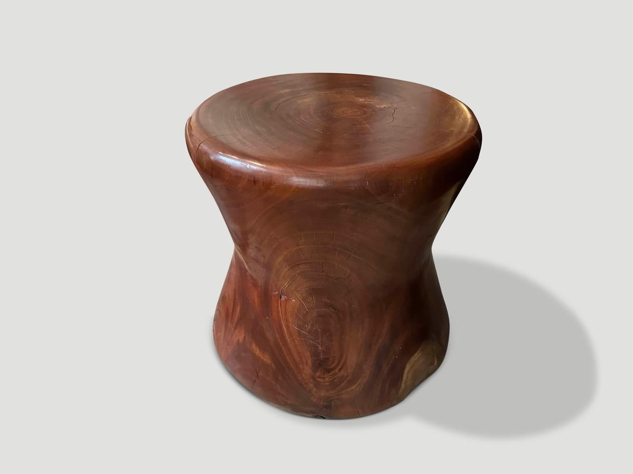Impressive antique mortar originally used to grind rice. We turned it upside down and smoothed out the entire piece revealing the beautiful wood grain. Repurposed into a sculptural side table or stool. Full dimensions ; The inside is 6” thick x 9”