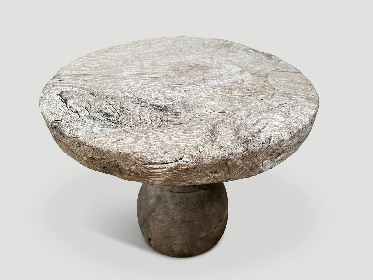 A unique table originally used to weave intricate baskets. The top is an impressive three inches thick and the sculptural base is solid teak wood. Finished in a translucent grey revealing the beautiful wood grain. It’s all in the details. 

This