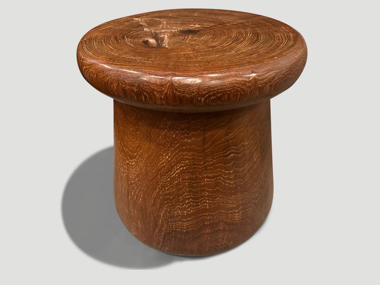 Antique mortar originally used to grind rice. We turned it upside down and smoothed out the entire piece revealing the beautiful wood grain. The inside is just eight inches hollow. Repurposed into a sculptural side table or stool. It’s all in the