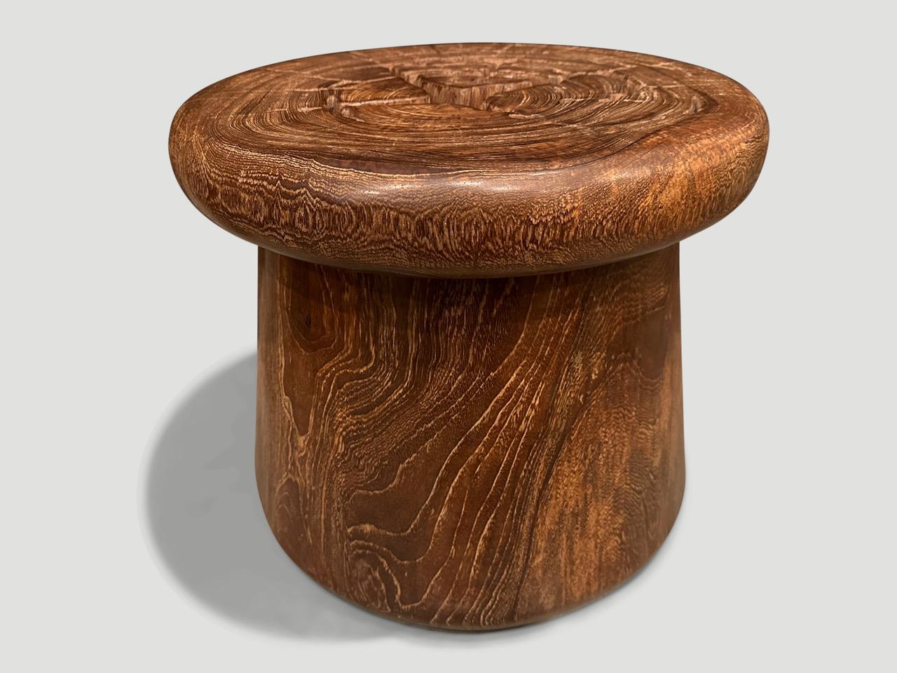 Antique mortar originally used to grind rice. We turned it upside down and smoothed out the entire piece revealing the beautiful wood grain.  Repurposed into a sculptural side table or stool. We have a small collection. The images and price reflect