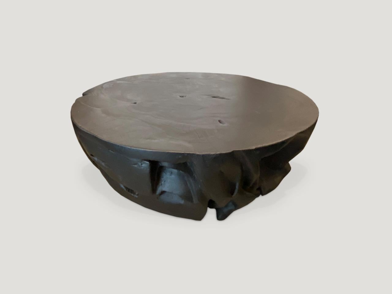 Impressive reclaimed teak wood coffee table hand carved from a massive single teak root. It’s rare to find a piece this large with the top section totally flat, smooth and usable.

The Triple Burnt Collection represents a unique line of modern
