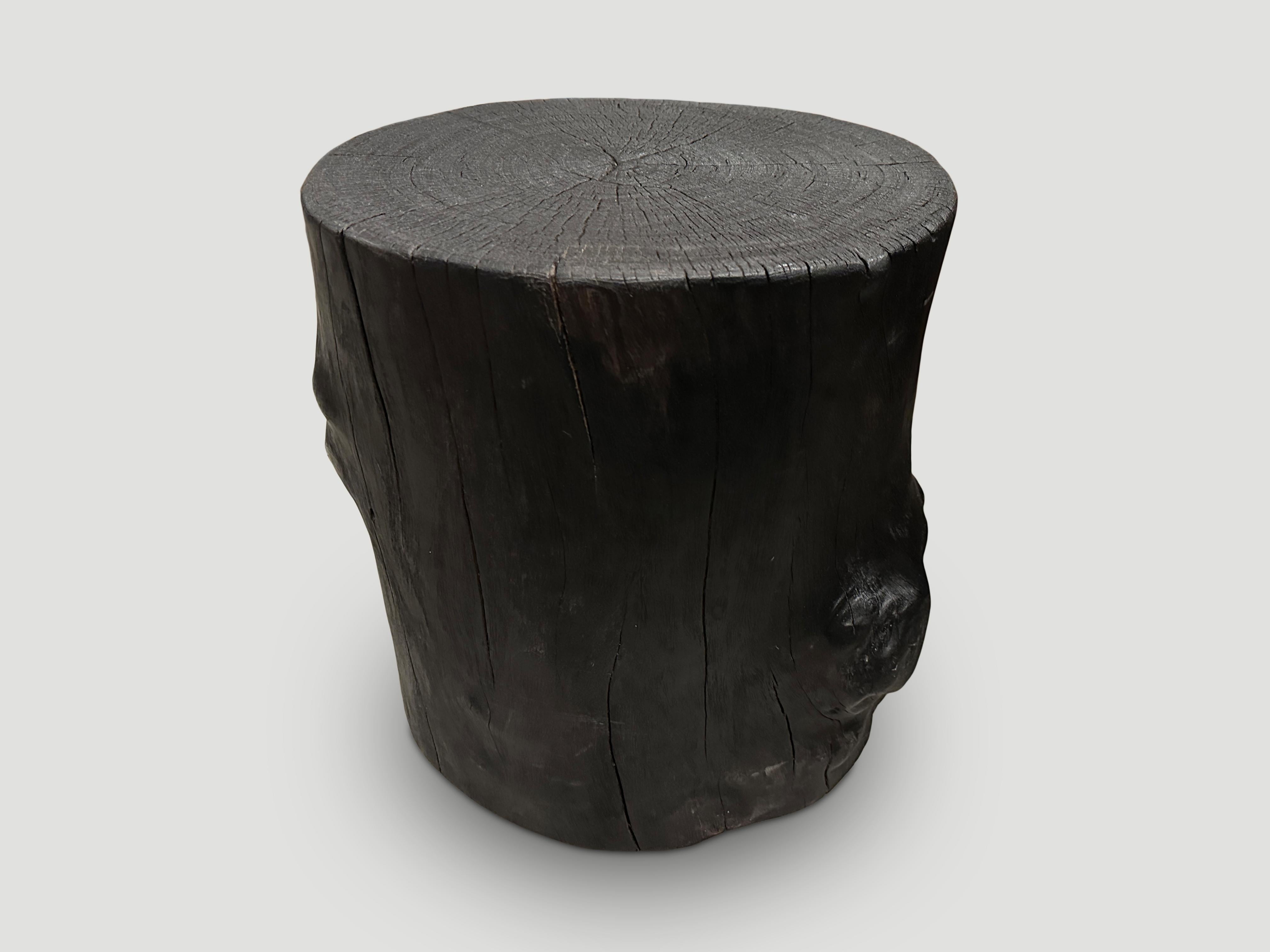 Reclaimed lychee wood side table. Burnt, sanded and sealed whilst respecting the natural organic shape. Sealed with a natural oil revealing the beautiful wood grain. 

The Triple Burnt Collection represents a unique line of modern furniture made