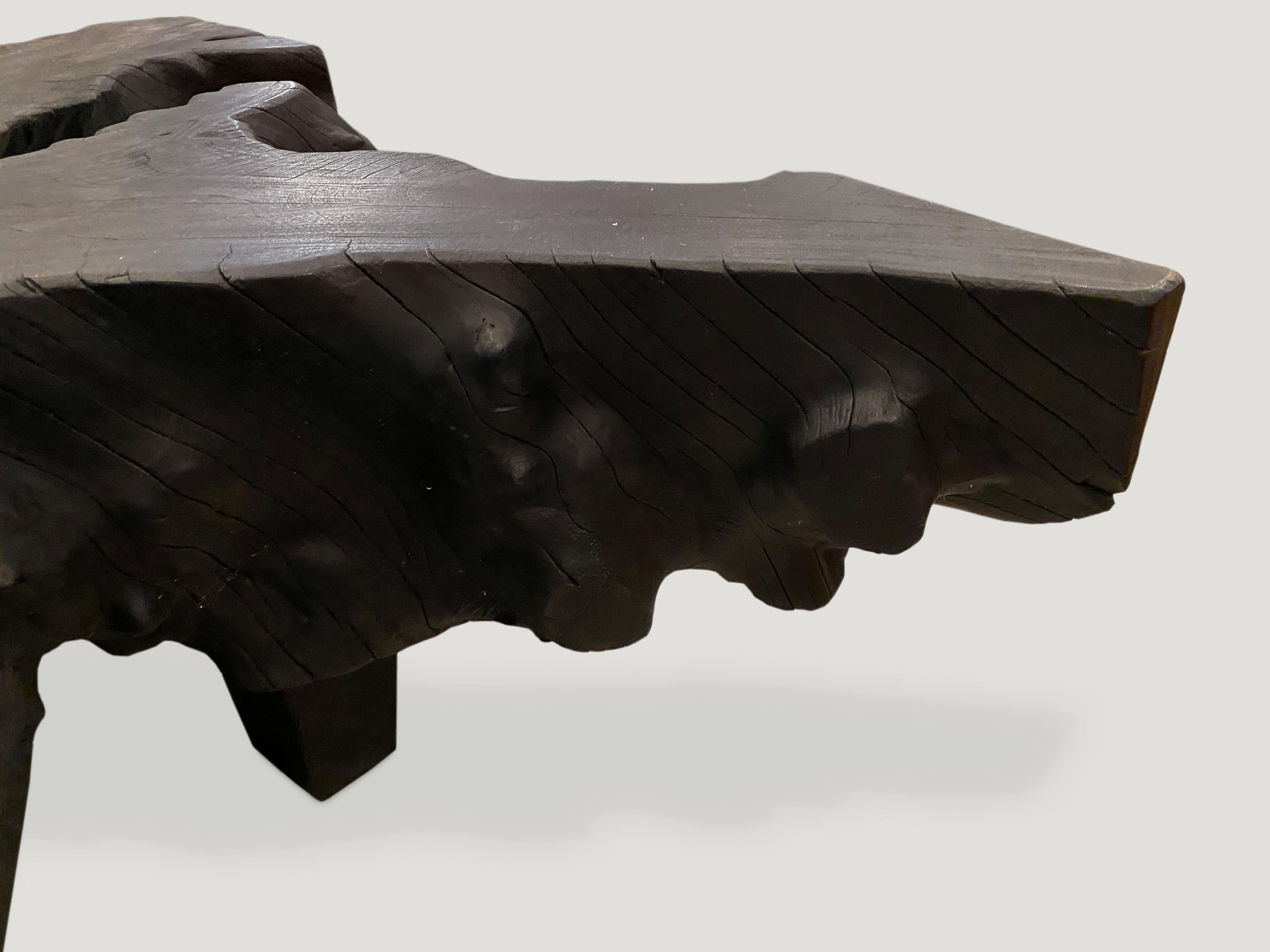 Impressive single reclaimed root mahogany coffee table. The top is 9” thick and floats off the floor on 7” high Minimalist block legs. Burnt, sanded and sealed exposing the beautiful grain of the wood.

The Triple Burnt collection represents a