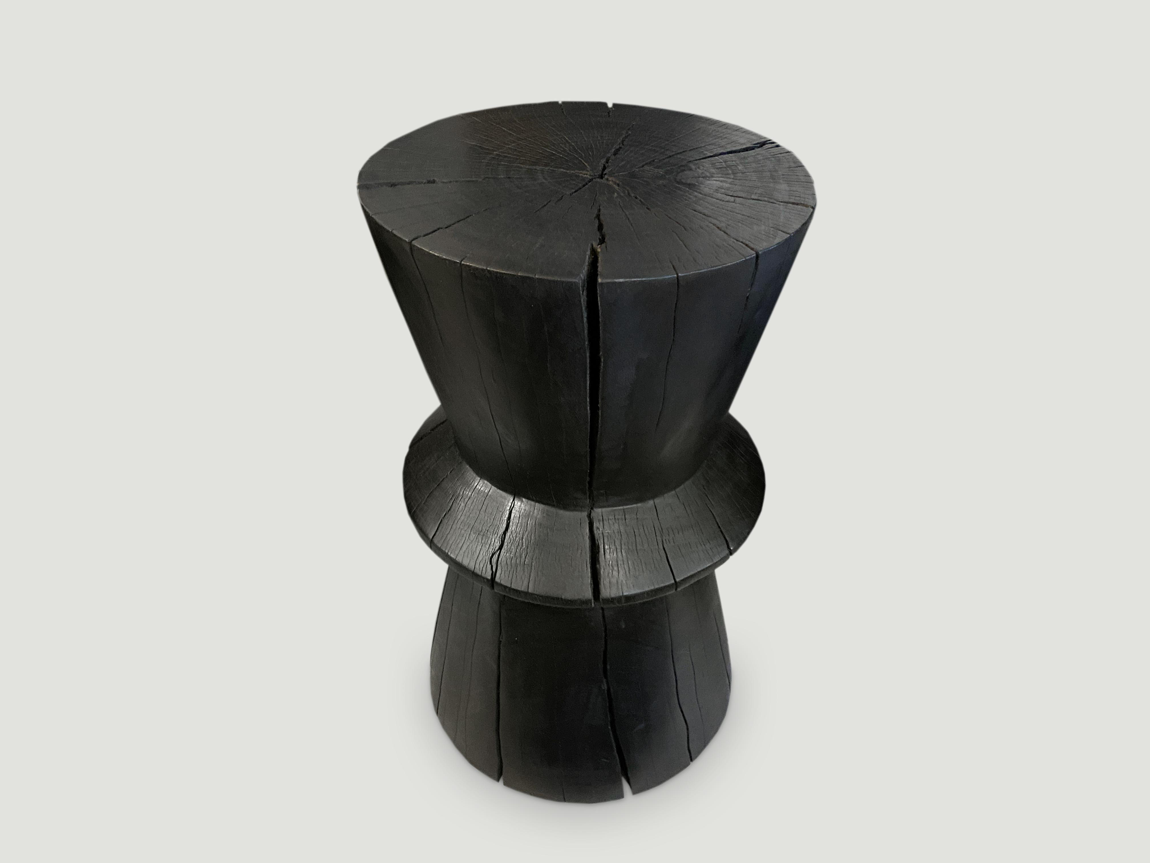 Hand carved side table made from reclaimed tamarind wood that celebrates cracks and crevices. We have a collection. The price reflects the one shown.

The Triple Burnt collection represents a unique line of modern furniture made from solid