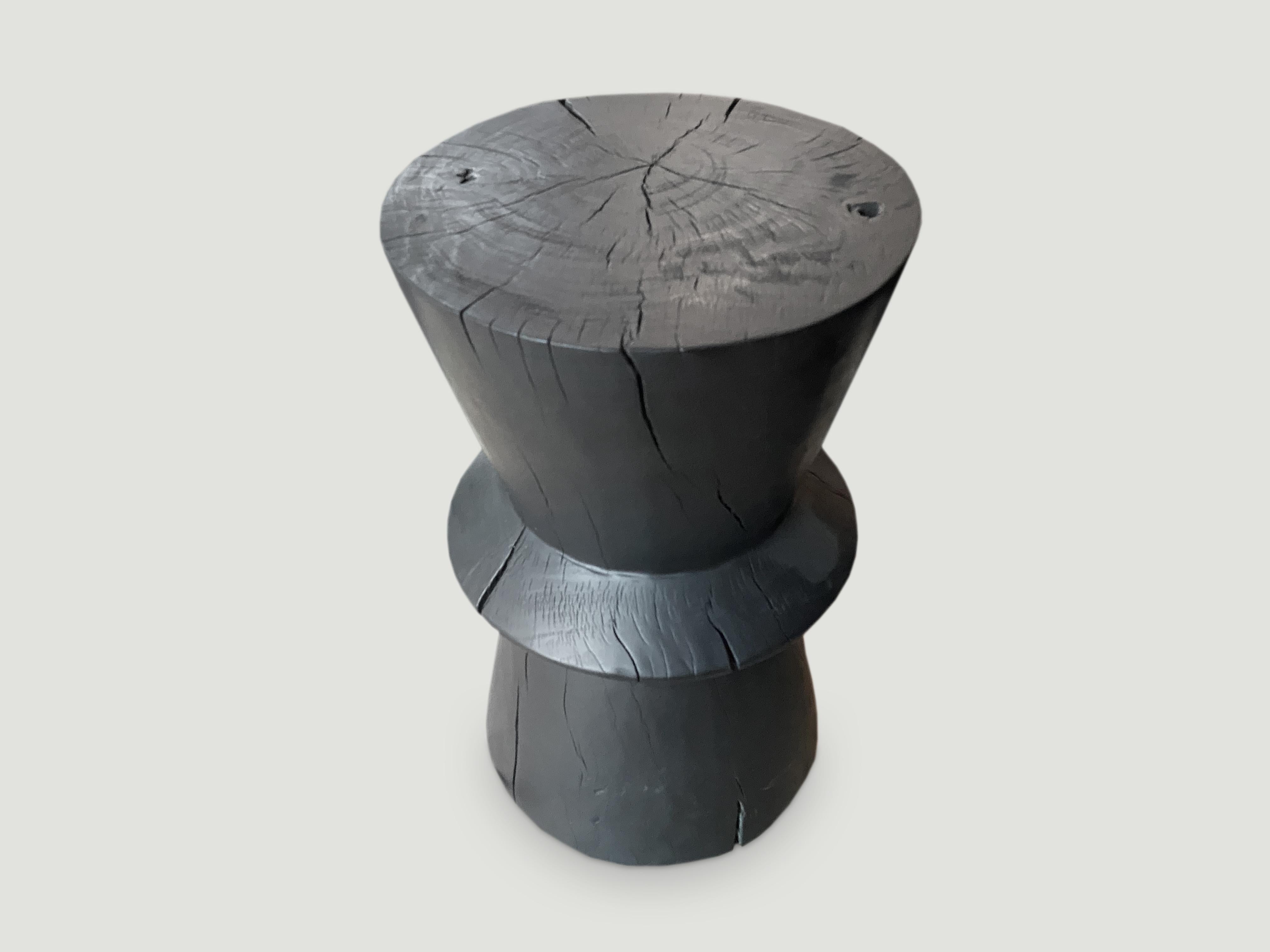 Hand carved side table that celebrates cracks and crevices found in reclaimed tamarind wood. We have a collection. The price and size reflect the one shown.

The Triple Burnt collection represents a unique line of modern furniture made from solid