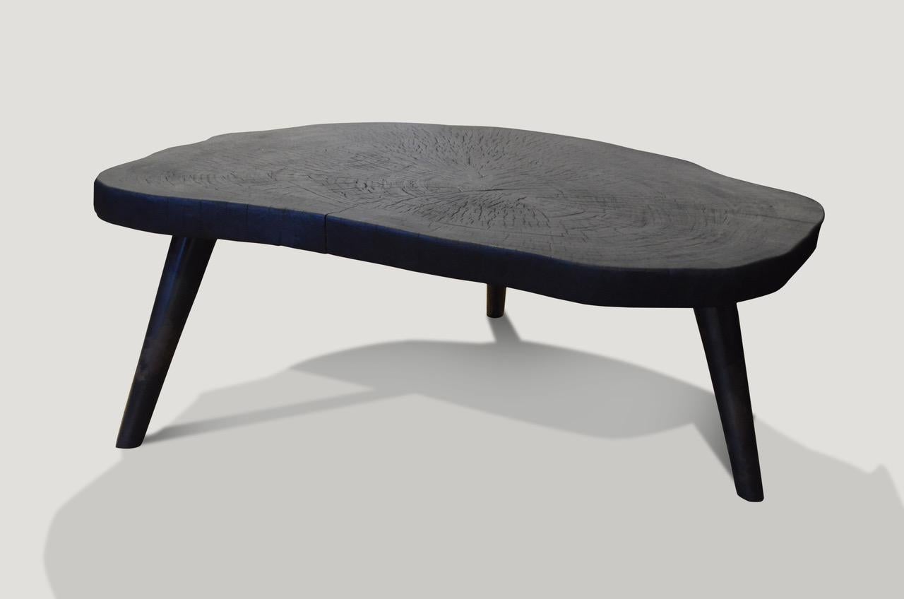 Stunning single 2 inch slab, over sized side table or coffee table. Charred and set on a midcentury style burnt metal base.

The Triple Burnt Collection represents a unique line of modern furniture made from solid organic wood. Burnt three times