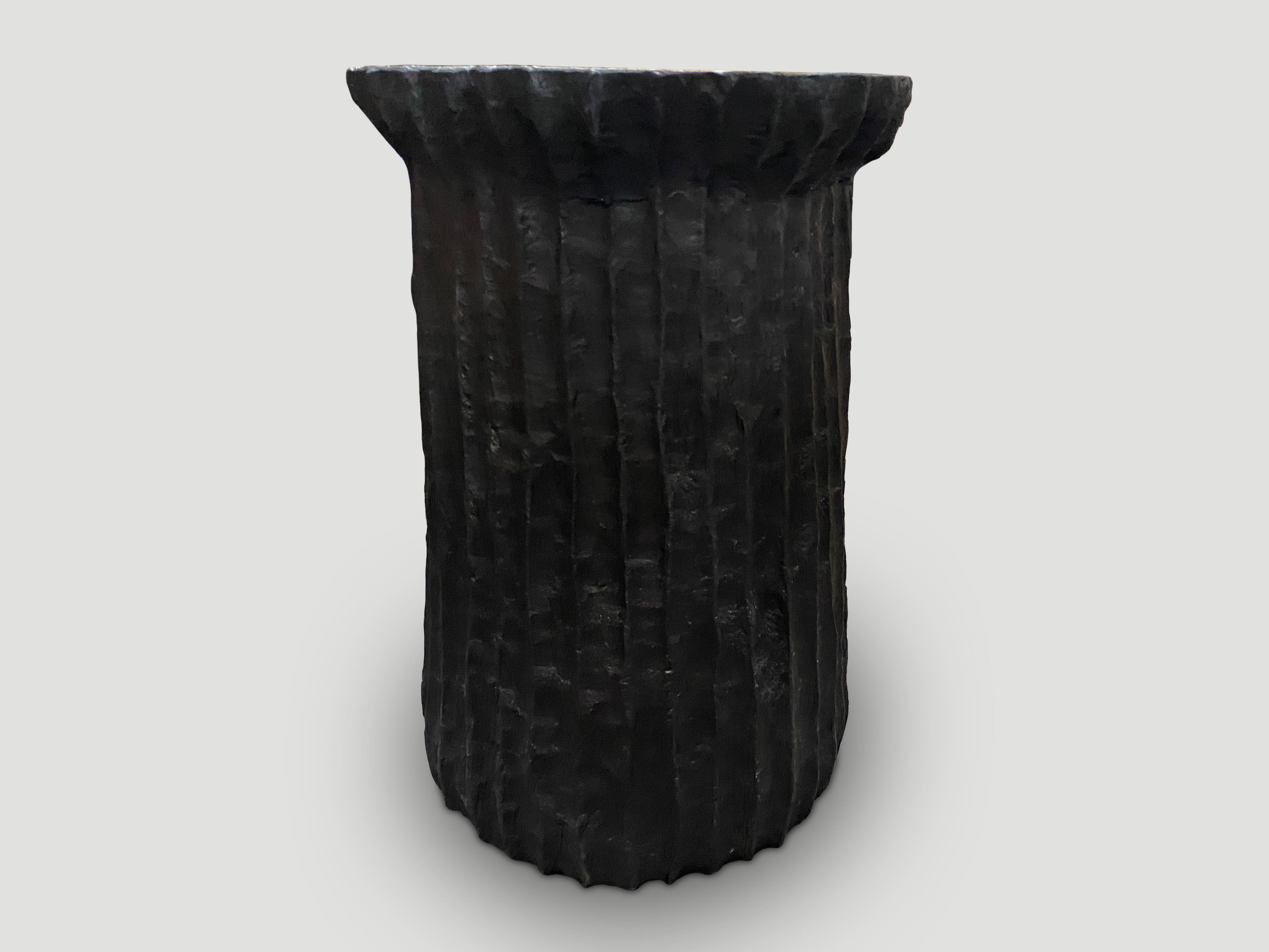 Beautiful hand carved minimalist charred teak wood side table or pedestal. We have a collection in different shapes and sizes. The price reflects the one shown. Also available bleached.

The Triple Burnt Collection represents a unique line of modern