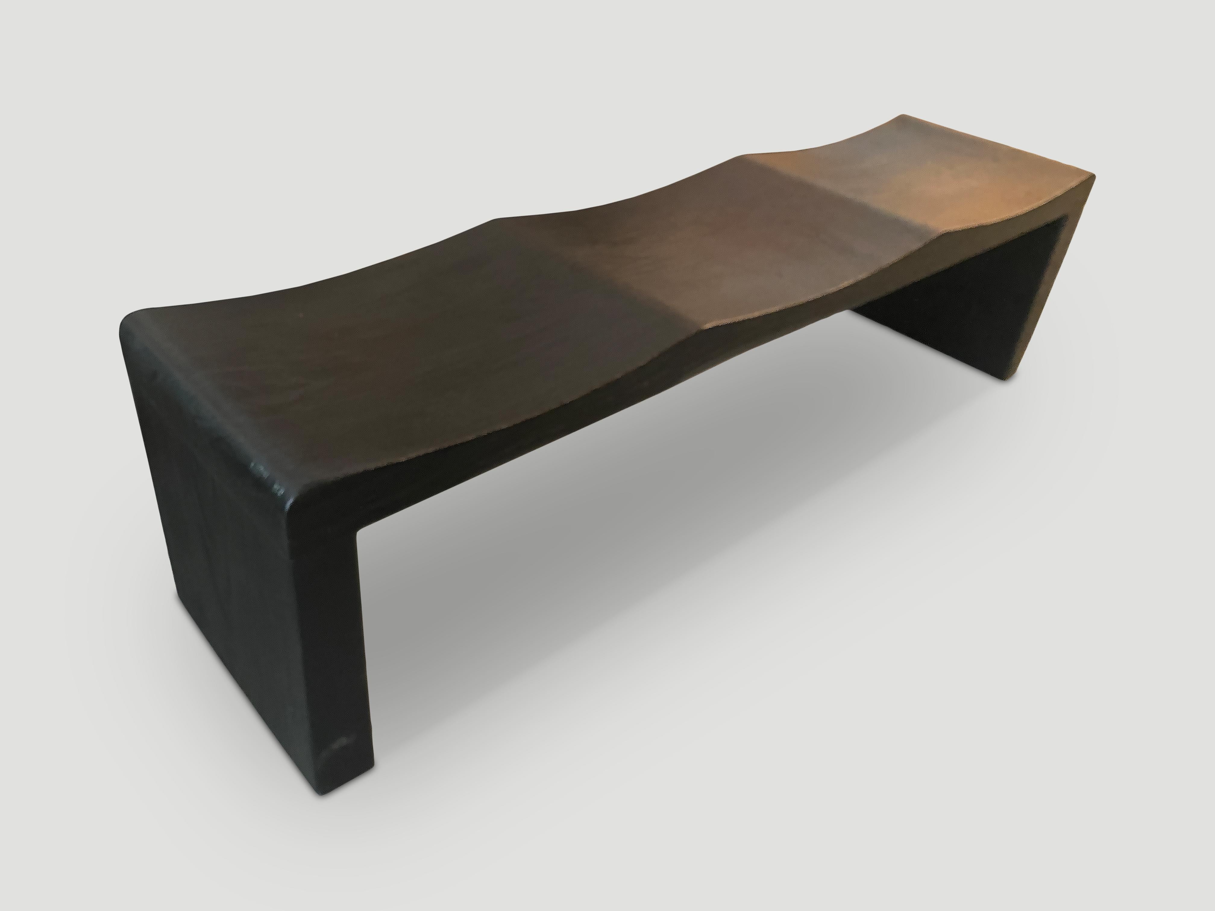 The teak wave bench represents a sleek, modern aesthetic, designed to provide comfort and durability. Solid reclaimed teak wood is hand carved into a wave design. Charred, sanded and sealed revealing the beautiful wood grain. Custom stains and