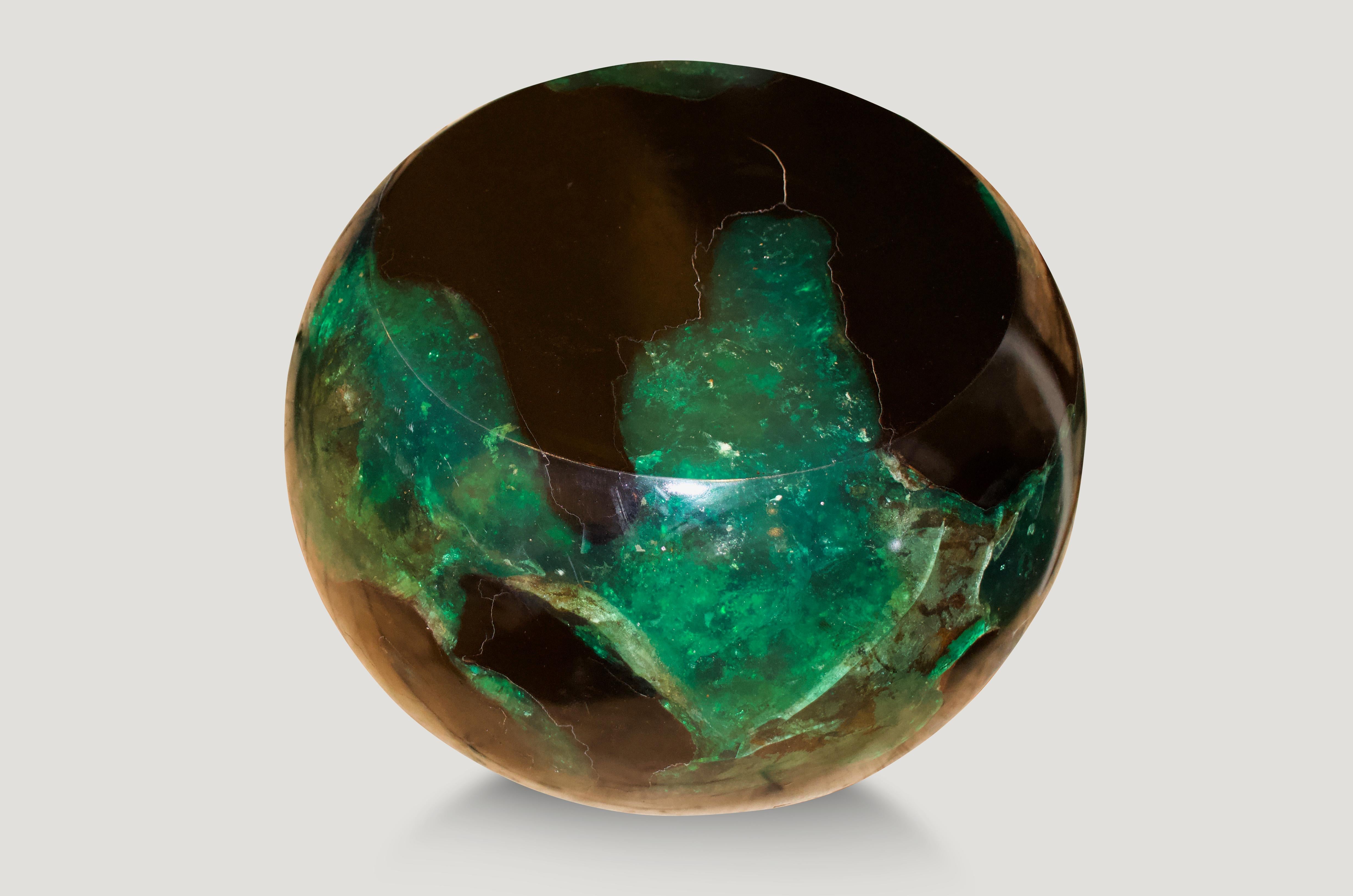 The cracked resin drum side table or stool is made from teak infused with emerald resin.

The Cracked Resin collection is a revolutionary line of modern coffee tables, side tables and dining tables made from organic teak and resin. The natural