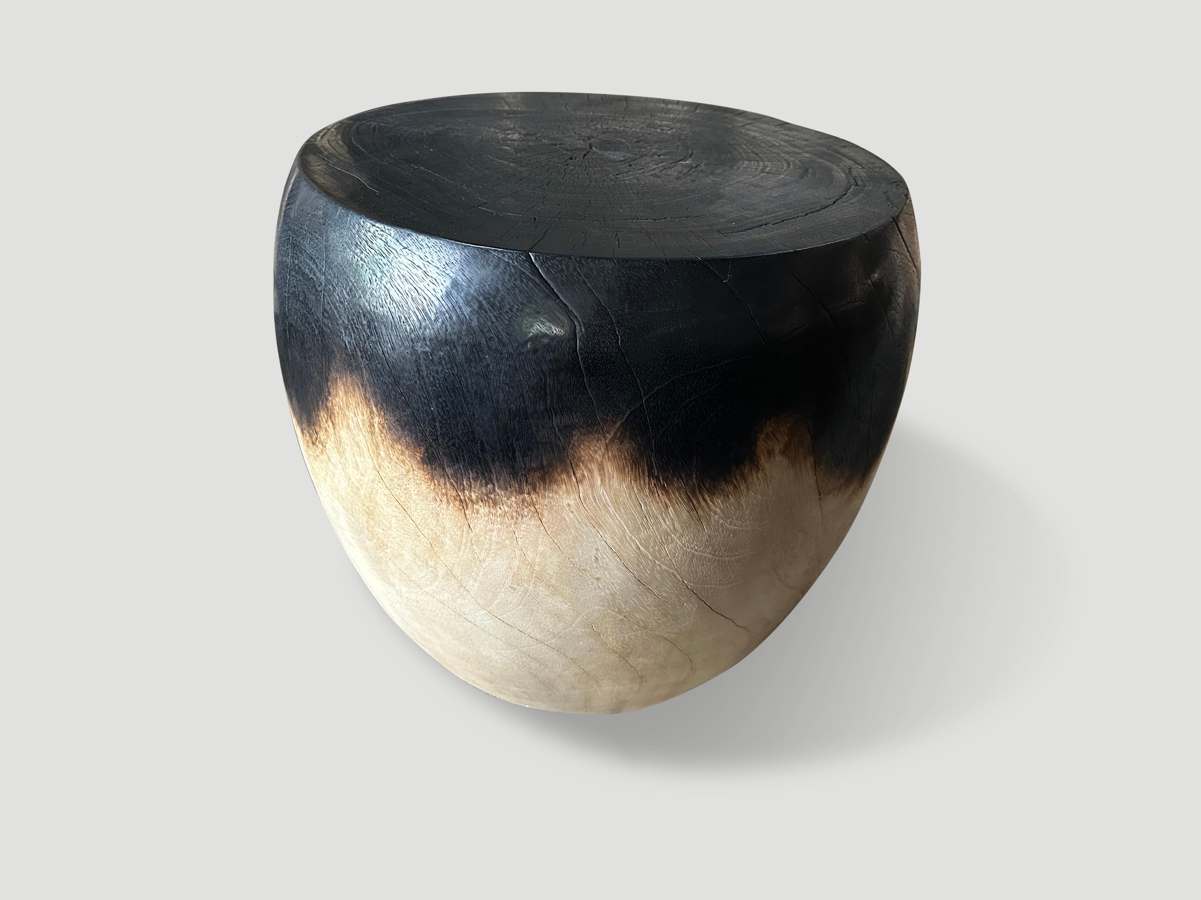 Partially charred reclaimed mango wood side table. Hand carved into an impressive drum shape. We added a natural oil revealing the beautiful wood grain. It’s all in the details. Full dimensions; Top 17″ diameter x center 19″ Diameter x 18″