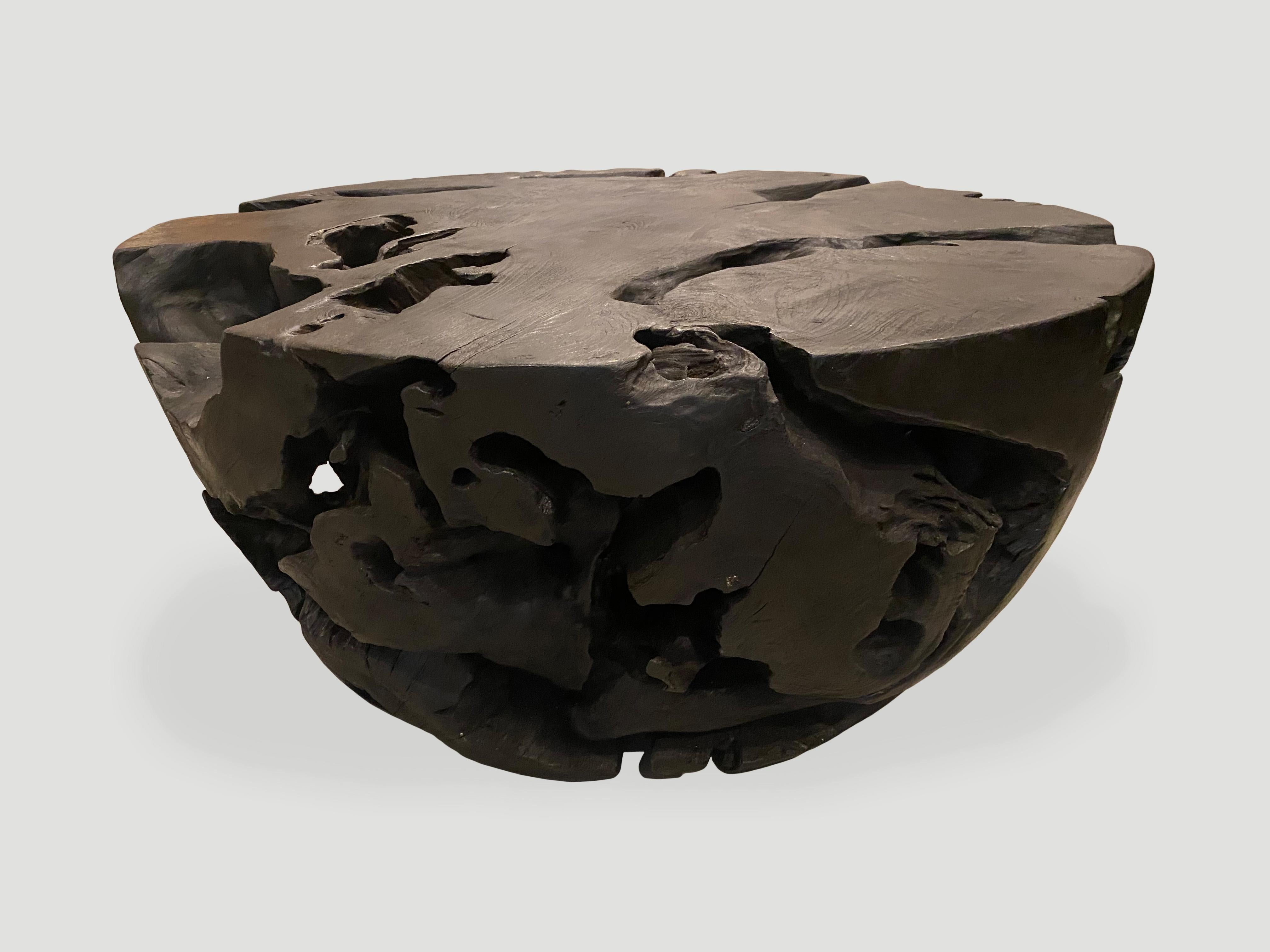 Organic hand carved drum shape reclaimed teak wood coffee table. Burnt, sanded and sealed with a smooth finish revealing the beautiful grain in the wood.

The Triple Burnt Collection represents a unique line of modern furniture made from solid