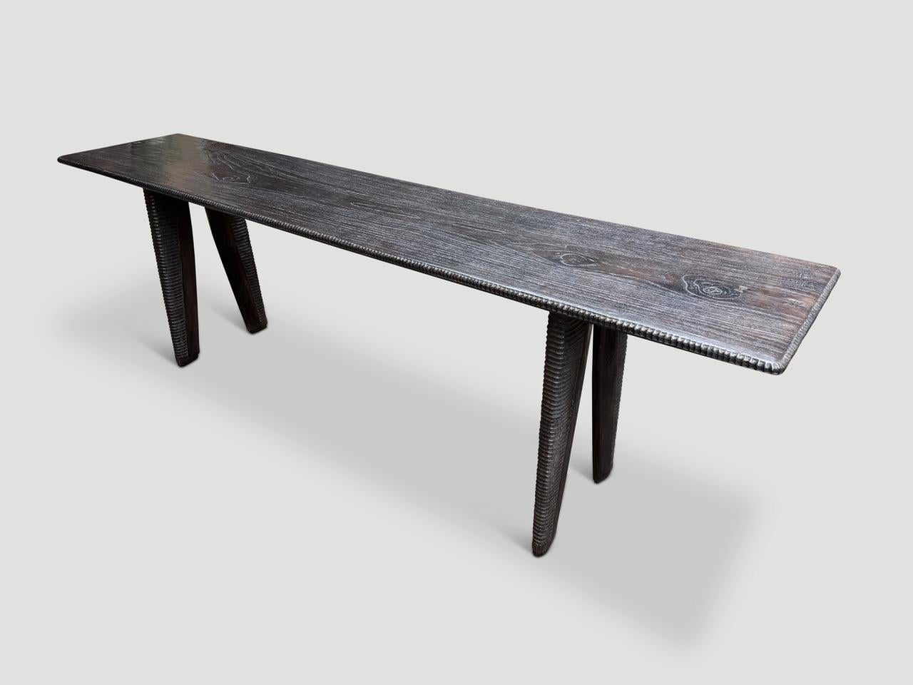 Century old teak wood from my finest collection is hand carved by our master carver to produce this one of a kind impressive table. Perfect as a console table or narrow dining table. Part of the Couture Collection. Furniture constructed by hand from