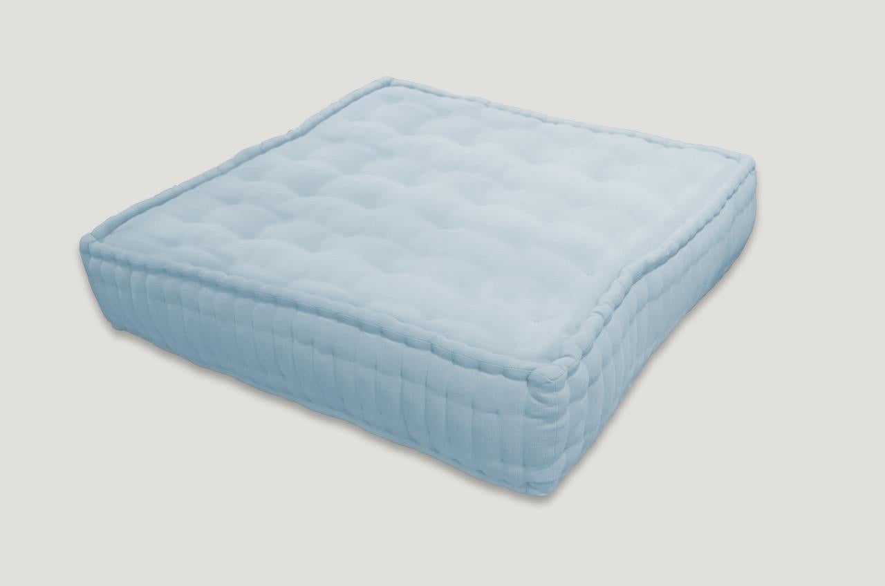 Cotton floor pillows. Available in tangerine and turquoise. The price reflects one.

      