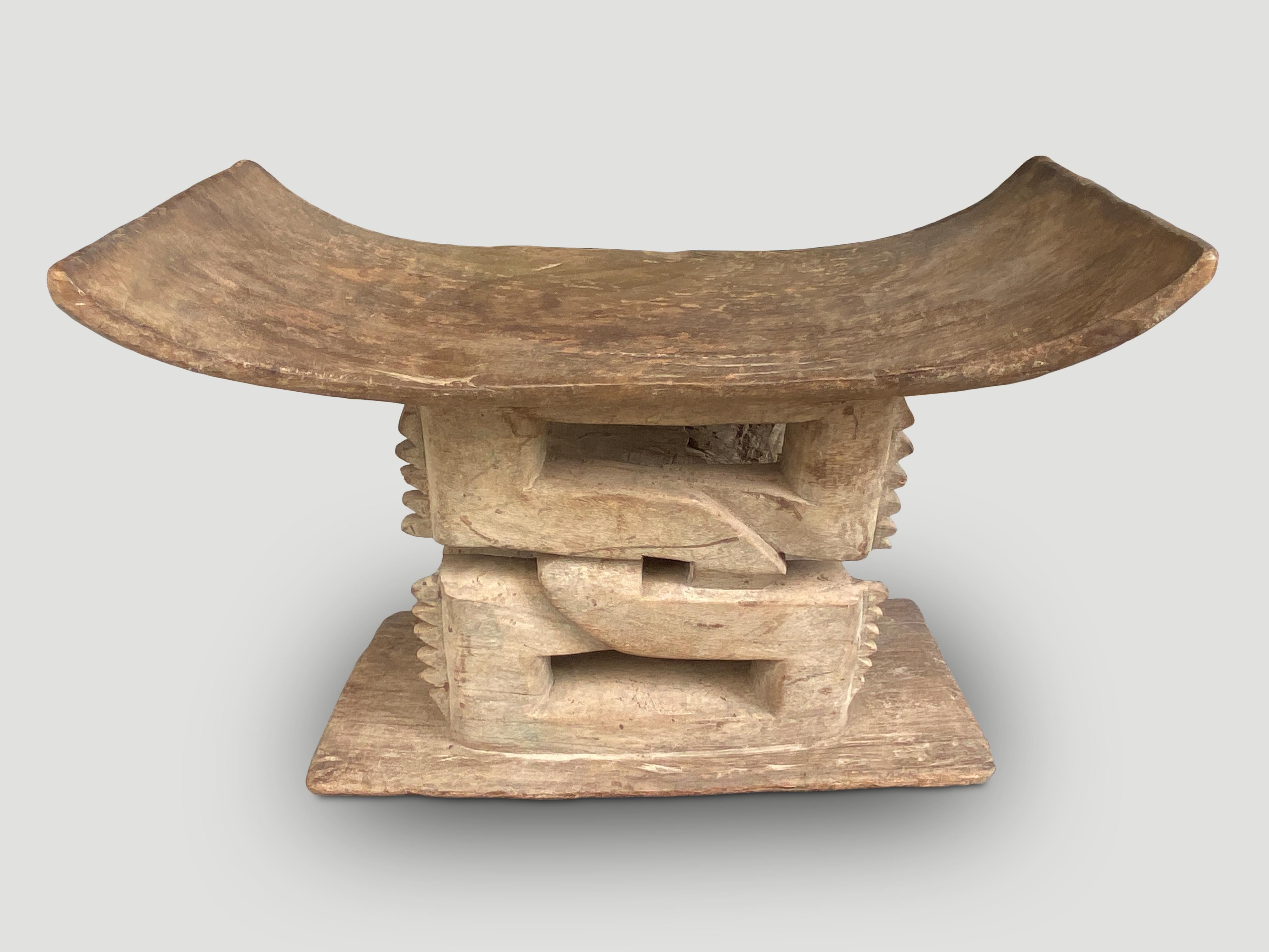 Beautiful detailing on this Ashanti stool hand carved from a single piece of wood. These were originally given as gifts upon marriage and passed from father to son with different designs and meanings. Circa early 20th Century. We only source the