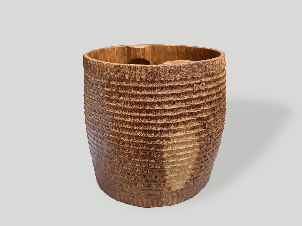 Originally used to carry water, this antique container has been hand carved by our master carver showing an impressive minimalist carving, to produce a sculptural container or if turned a unique side table. We added butterfly details on the side and