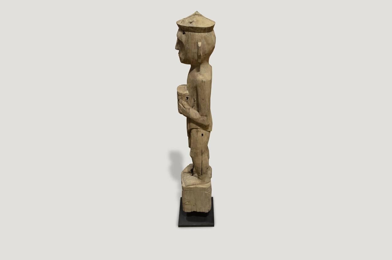 Antique hand-carved statue from a single teak wood log, from Sumatra. Originally used to protect the home. Set on a modern black steel base.

This statue was sourced in the spirit of wabi-sabi, a Japanese philosophy that beauty can be found in