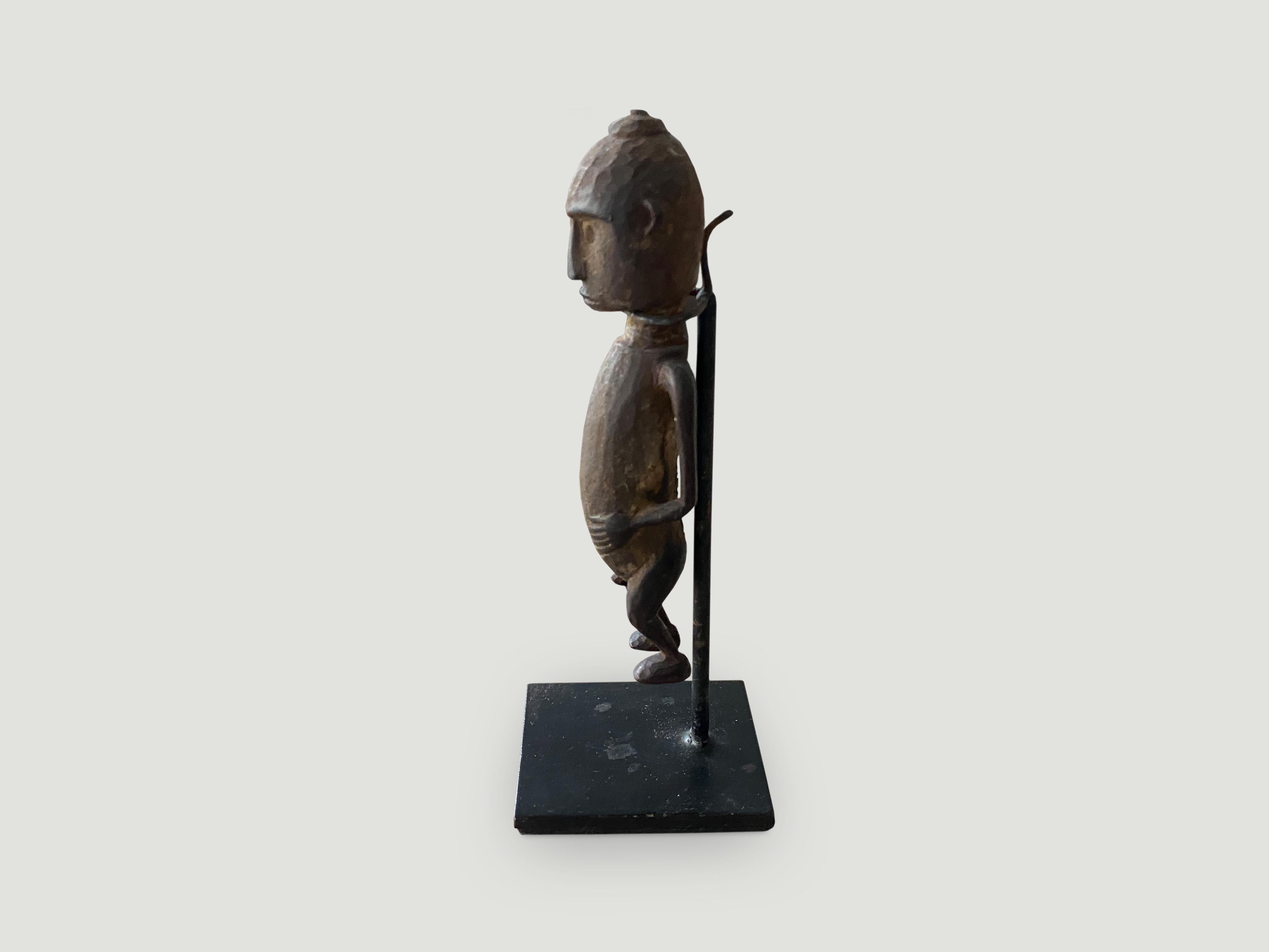 Hand carved wooden figurine of a primitive man from Sumatra. Set on a modern black metal stand, circa 1950

This figurine was sourced in the spirit of wabi-sabi, a Japanese philosophy that beauty can be found in imperfection and impermanence. It