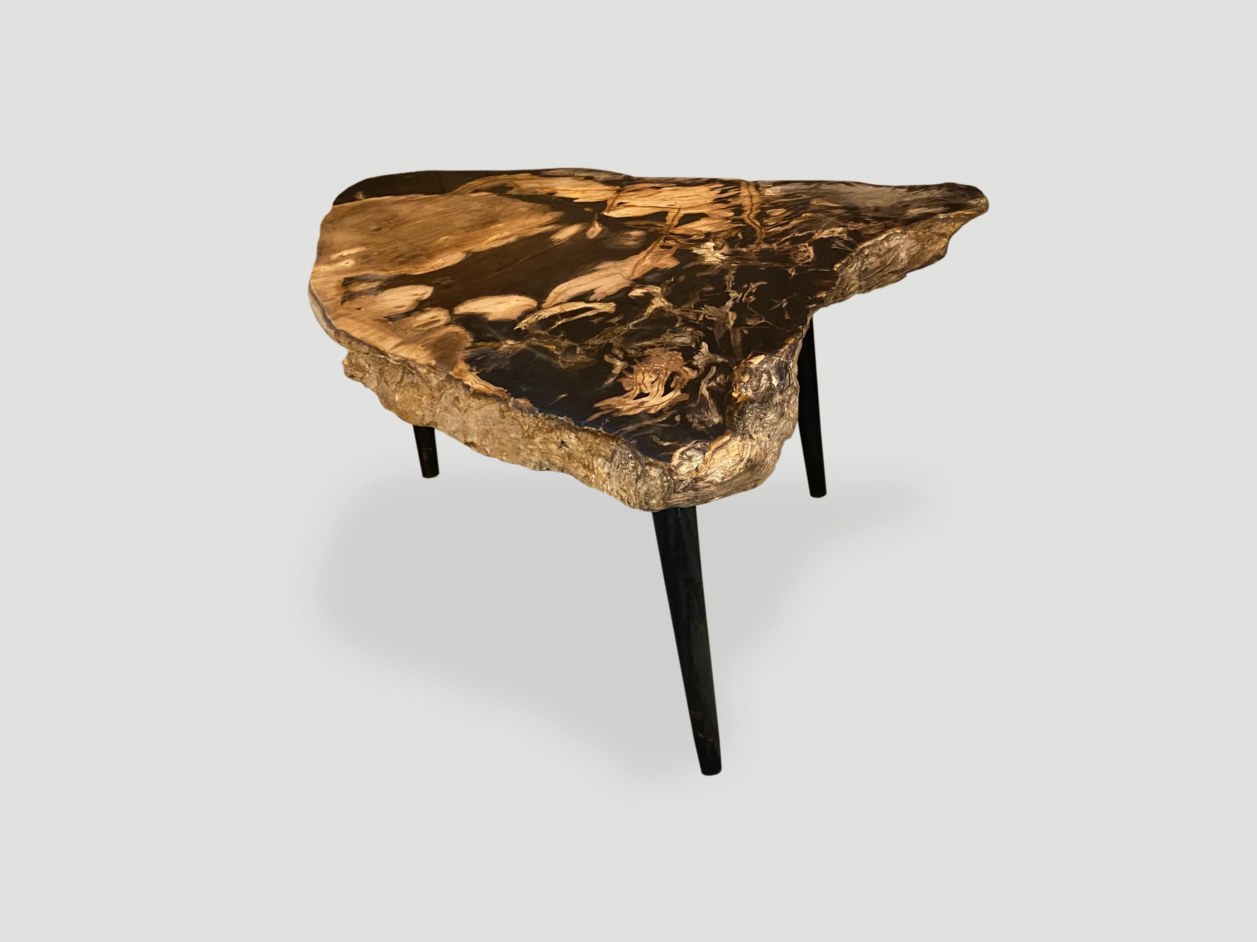 Beautiful contrasting colors on this stunning 2.5” thick petrified wood slab top side table. This live edge slab is resting on a midcentury style metal base. We added a coat of resin to the top. You saw it here first. We have two cut from the same