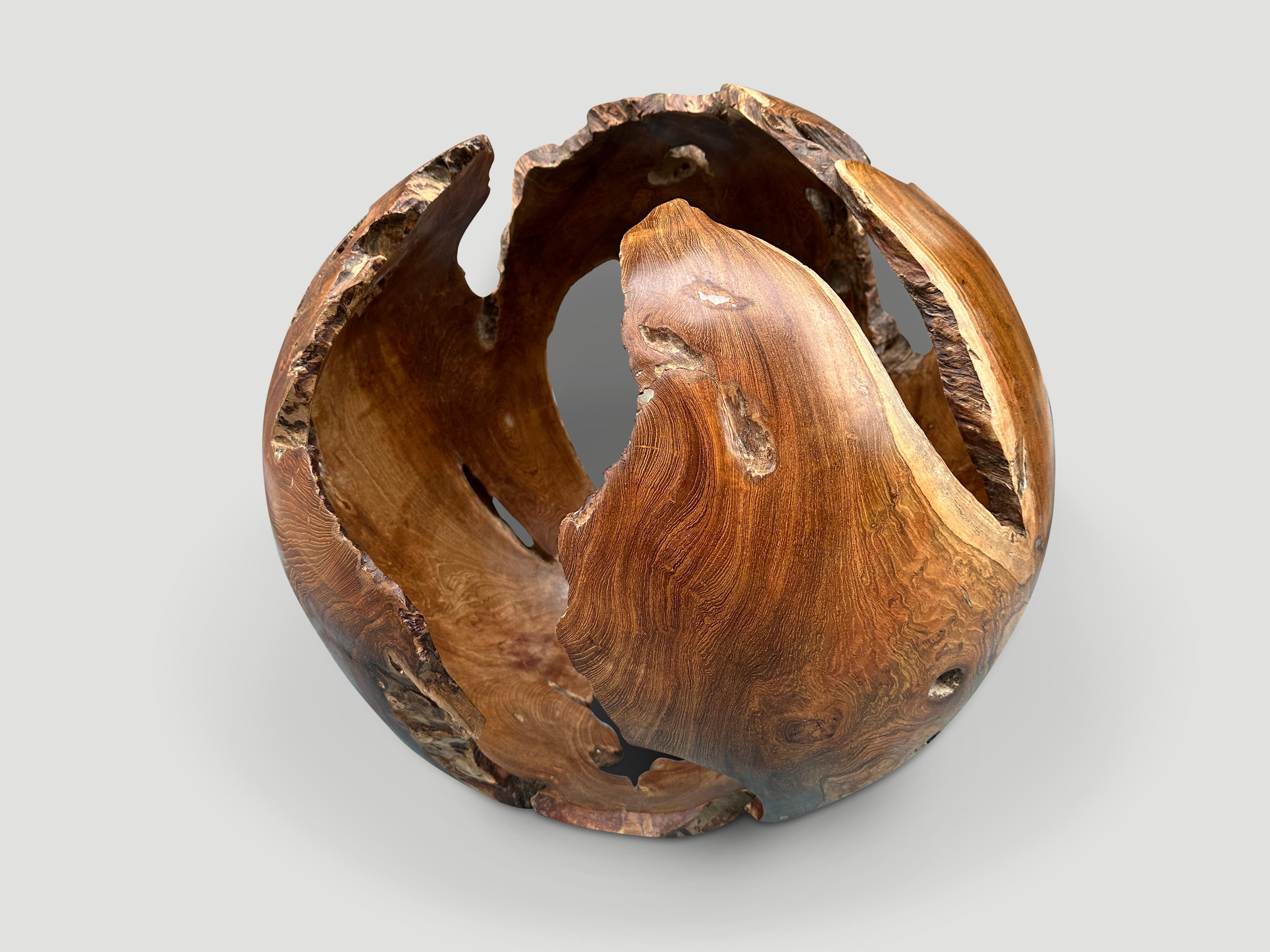 Impressive hollowed out sculptural sphere. Finished with a natural oil revealing the beautiful wood grain. This organic sculpture is stable resting on either side.

This sculpture was hand made in the spirit of Wabi-Sabi, a Japanese philosophy that