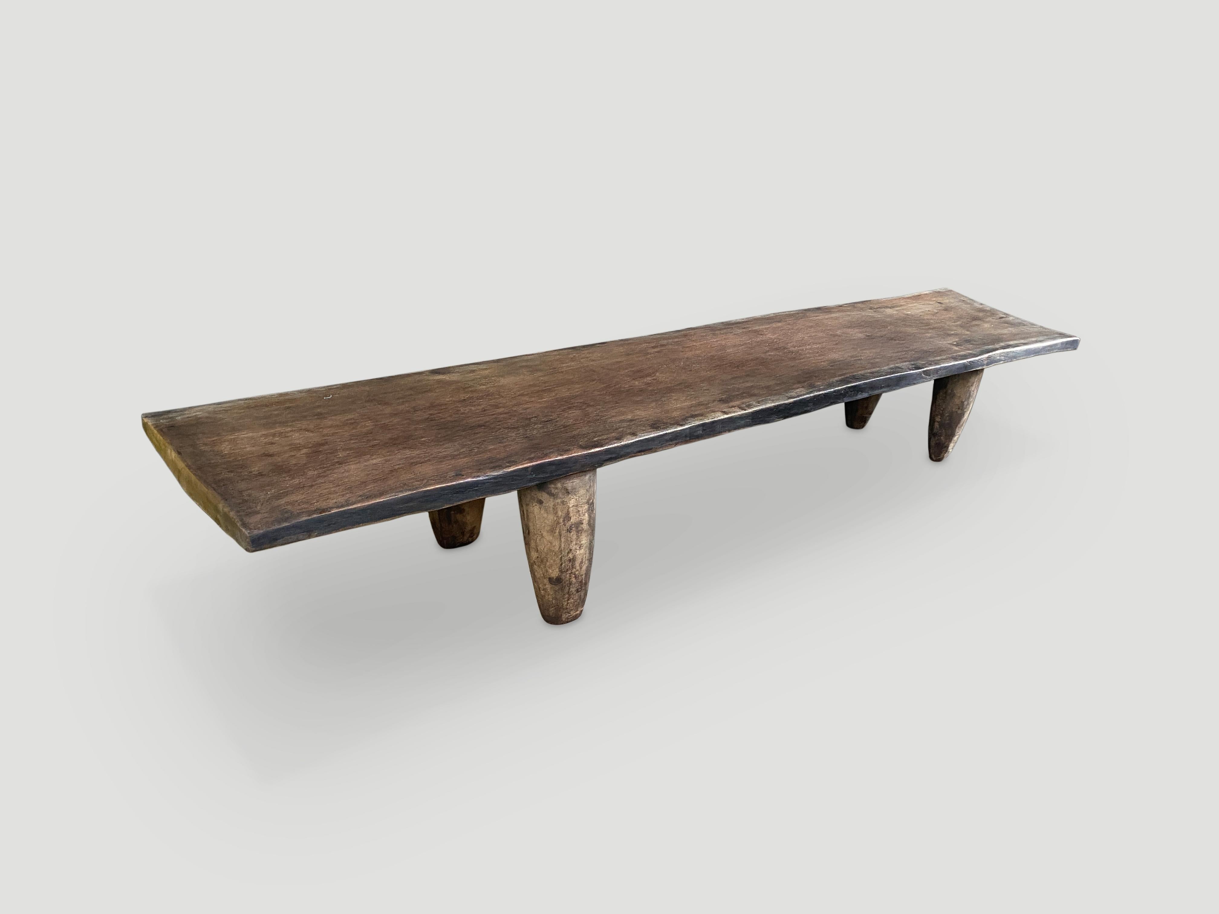 Rare antique coffee table hand carved by the Senufo tribes from a single block of Iroko wood, native to the west coast of Africa. The wood is tough, dense and very durable. Shown with hand carved cone style legs. We only source the best. This one is