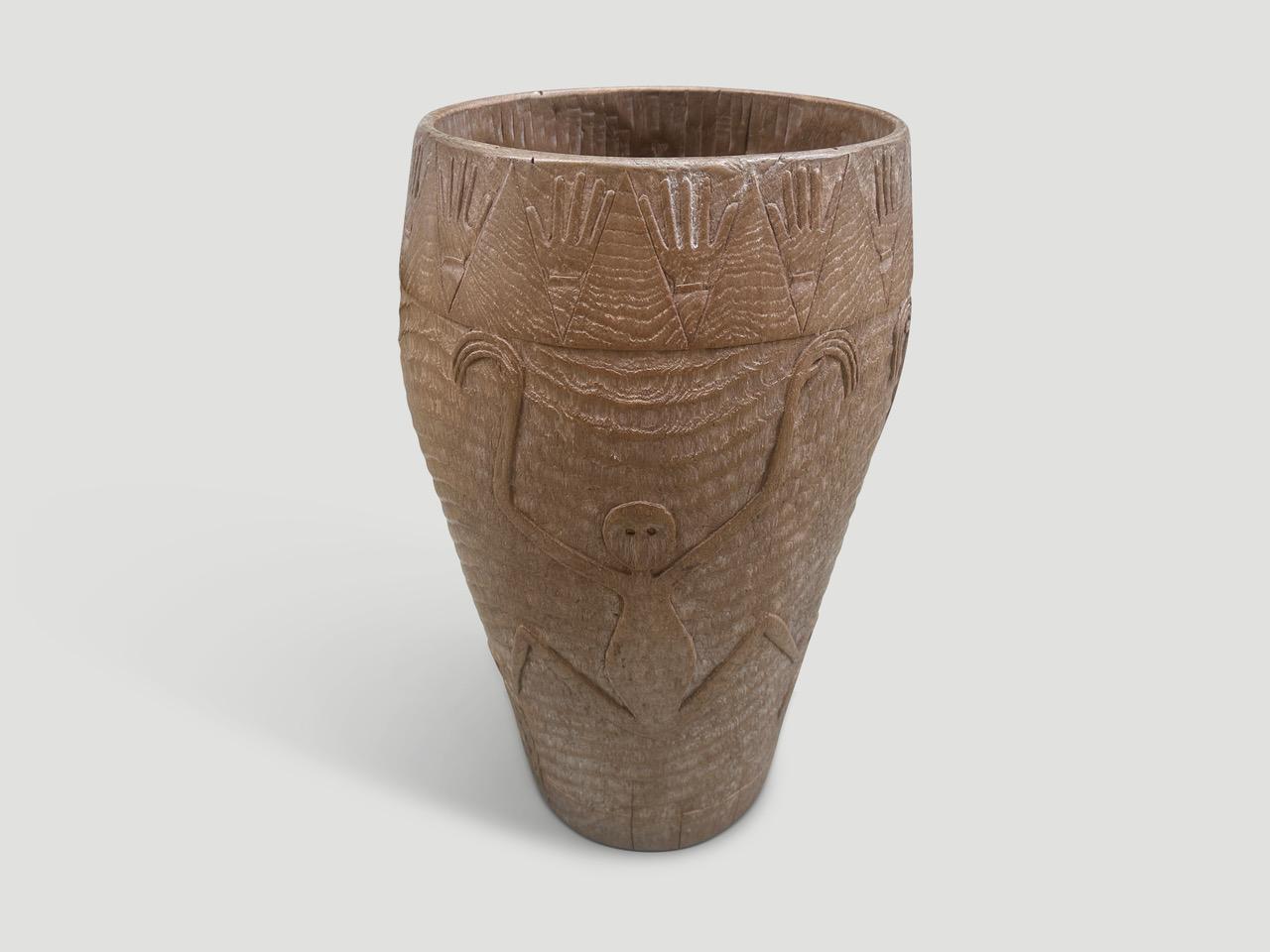 This exquisite antique drum, crafted from solid teak wood, hails from the lush landscapes of Bali. The top has been gracefully removed, allowing our master carver to delicately etch our signature minimalist designs into the time-seasoned teak. Along
