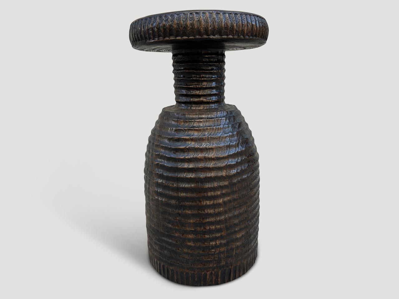A century old mortar originally used to grind rice is repurposed into this one of a kind side table featuring our unique minimalist carving. We added a translucent chocolate stain revealing the beautiful wood grain. Both usable and sculptural. It’s