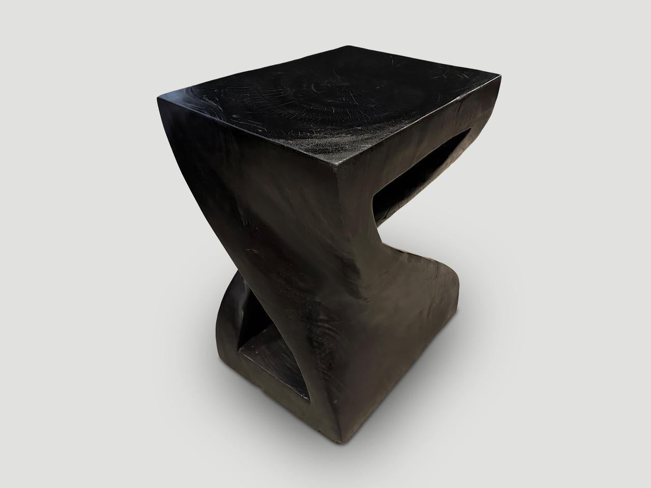 Impressive reclaimed suar wood pedestal. Hand carved into this stunning shape from a single block of wood. Charred, sanded and sealed revealing the beautiful wood grain. Both usable and sculptural.

The Triple Burnt Collection represents a unique