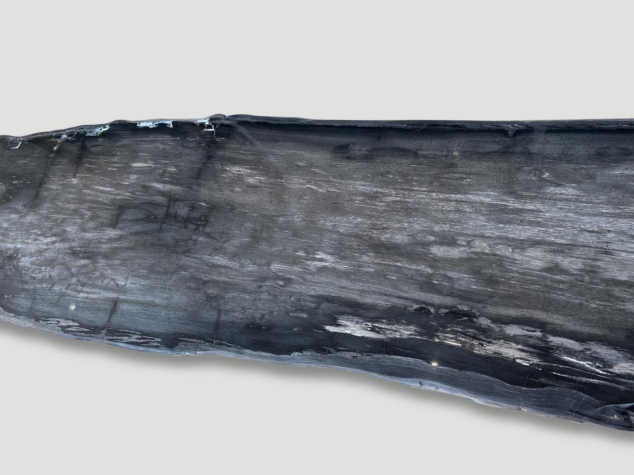 Impressive live edge single slab with stunning natural, contrasting markings. This can be made into a dining table, console table or counter top. The live edge is 22-27″ wide and the slab is three inches thick. The price does not include a base of