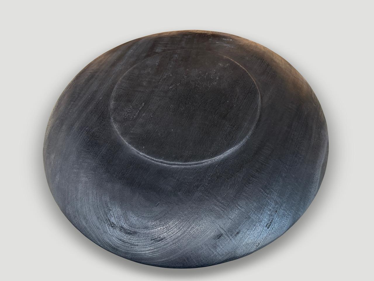 Beautiful oversized wood platter or bowl hand carved from a single piece of suar wood. The backs are flat and can therefore be installed on a wall. Also a practical addition to serve food, hold magazines, towels, etc. Charred, sanded and sealed