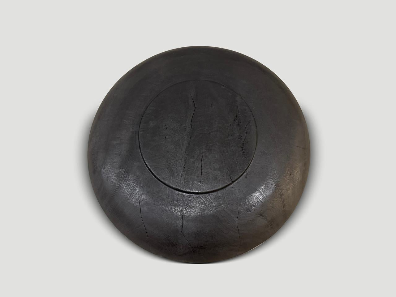 Beautiful oversized wood platter or bowl hand carved from a single piece of suar wood. The backs are flat and can therefore be installed on a wall. Also a practical addition to serve food, hold magazines, towels, etc. Charred, sanded and sealed