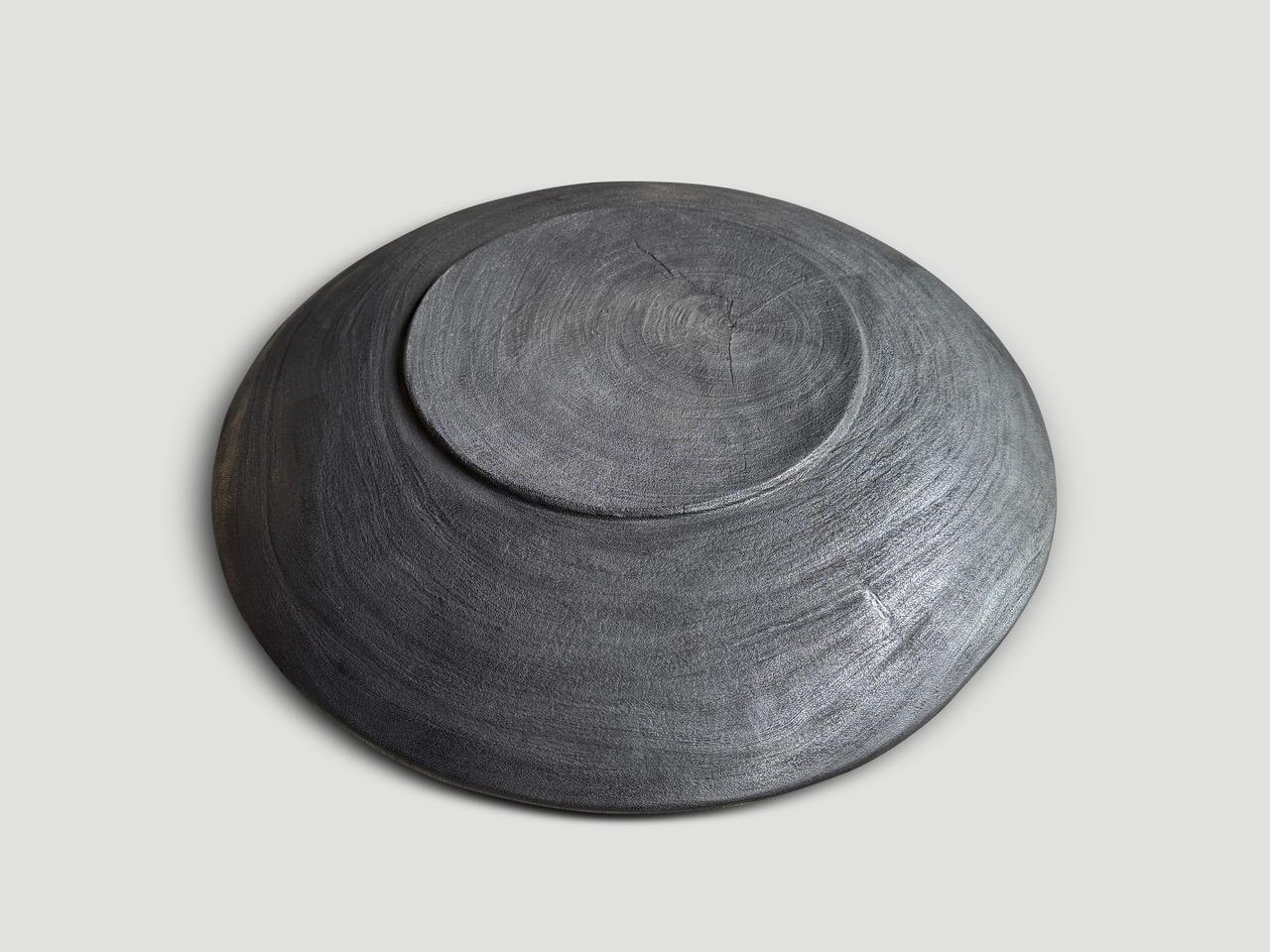 Beautiful oversized wood platter or bowl hand carved from a single piece of suar wood. The backs are flat and can therefore be installed on a wall. Also a practical addition to serve food, hold magazines, towels, etc. Charred, sanded and sealed