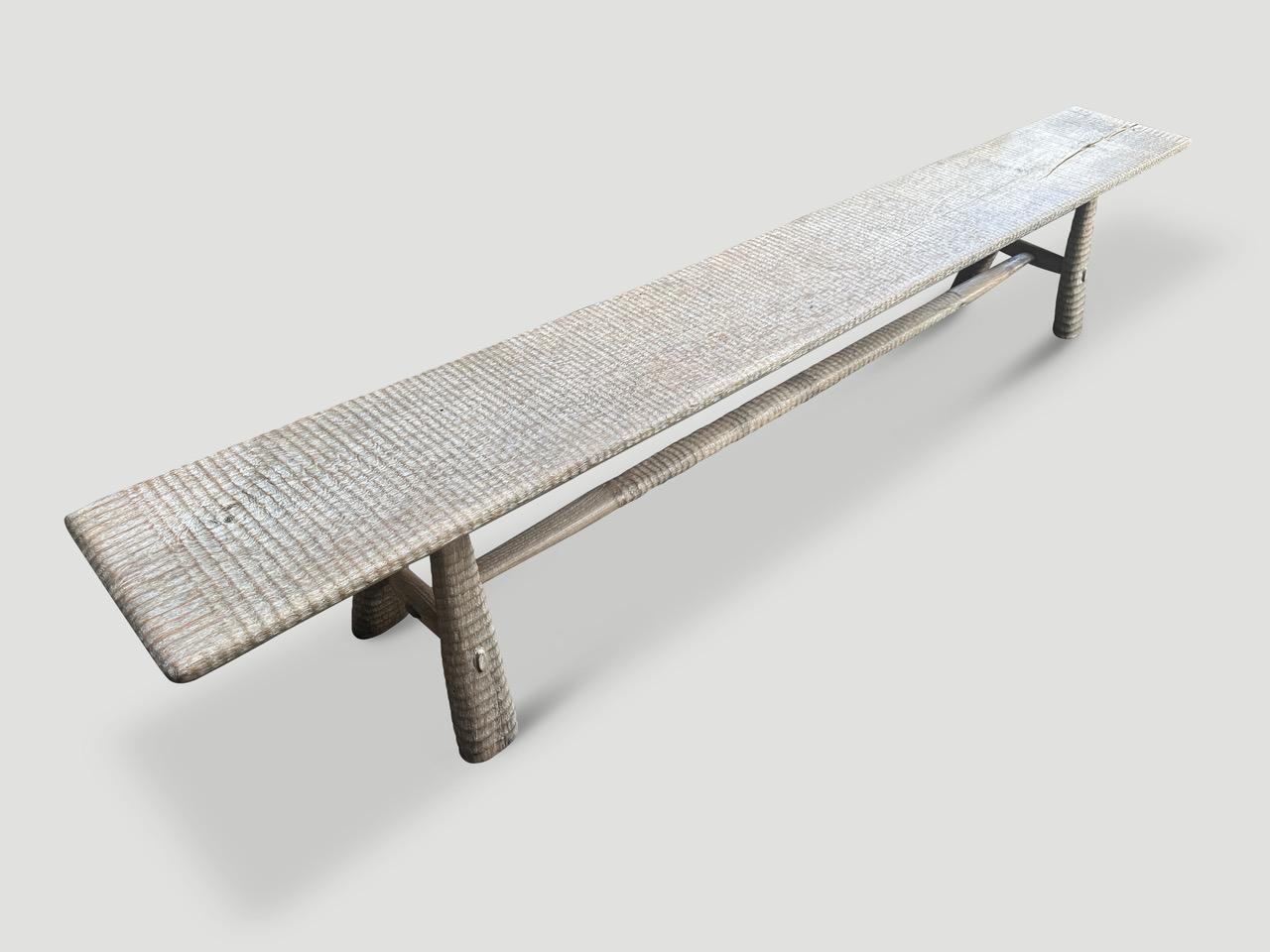 A beautiful single slab of teak wood taken from my finest collection is hand carved by our master carver to produce this impressive bench. The Mid-Century Couture Collection, features our unique minimalist carving. We added mid century style legs to