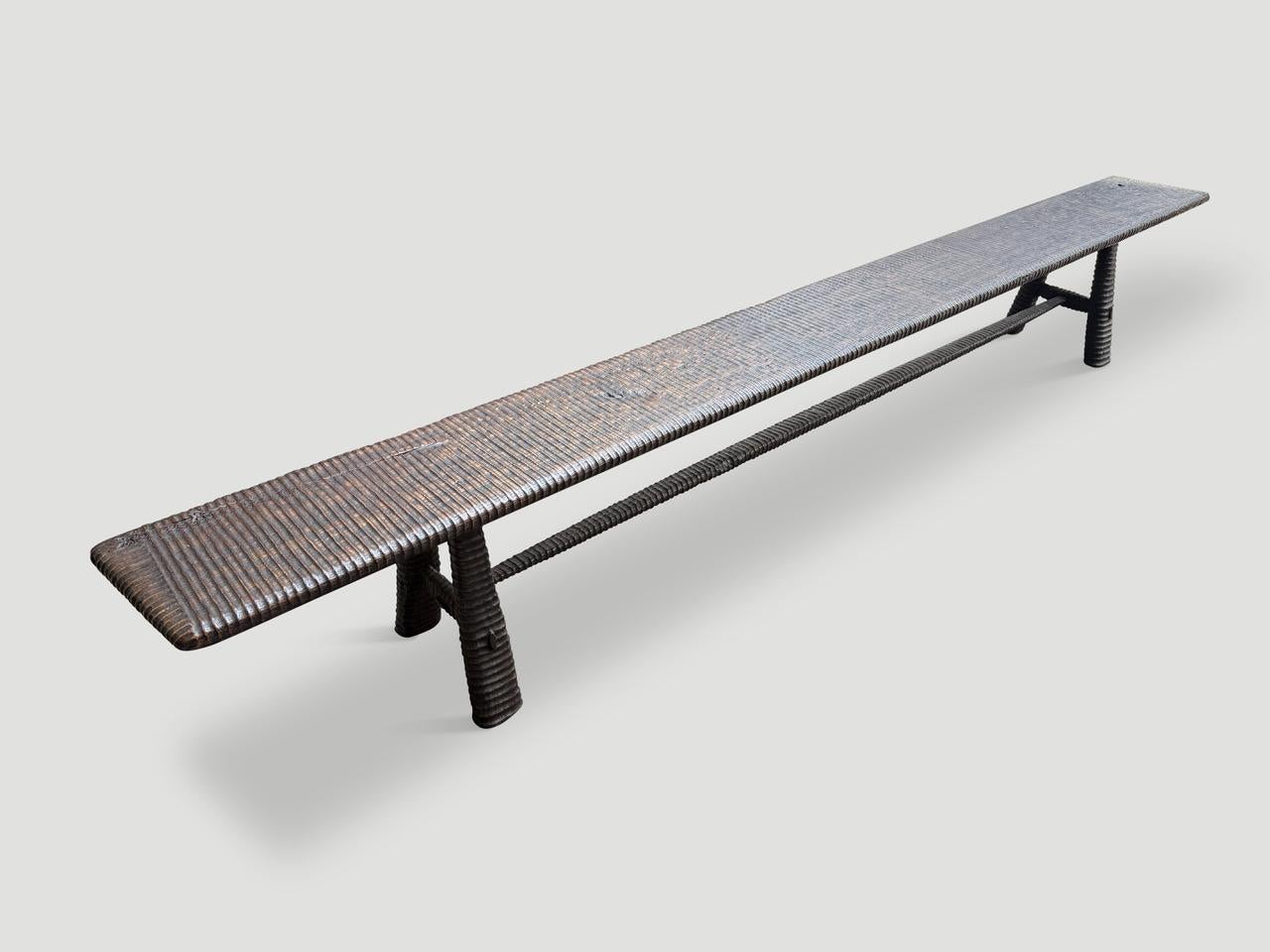 A beautiful single slab of teak wood from my finest collection is hand carved by our master carver to produce this impressive bench. The Mid-Century Couture Collection, features our unique minimalist carving. We added mid century style legs to this