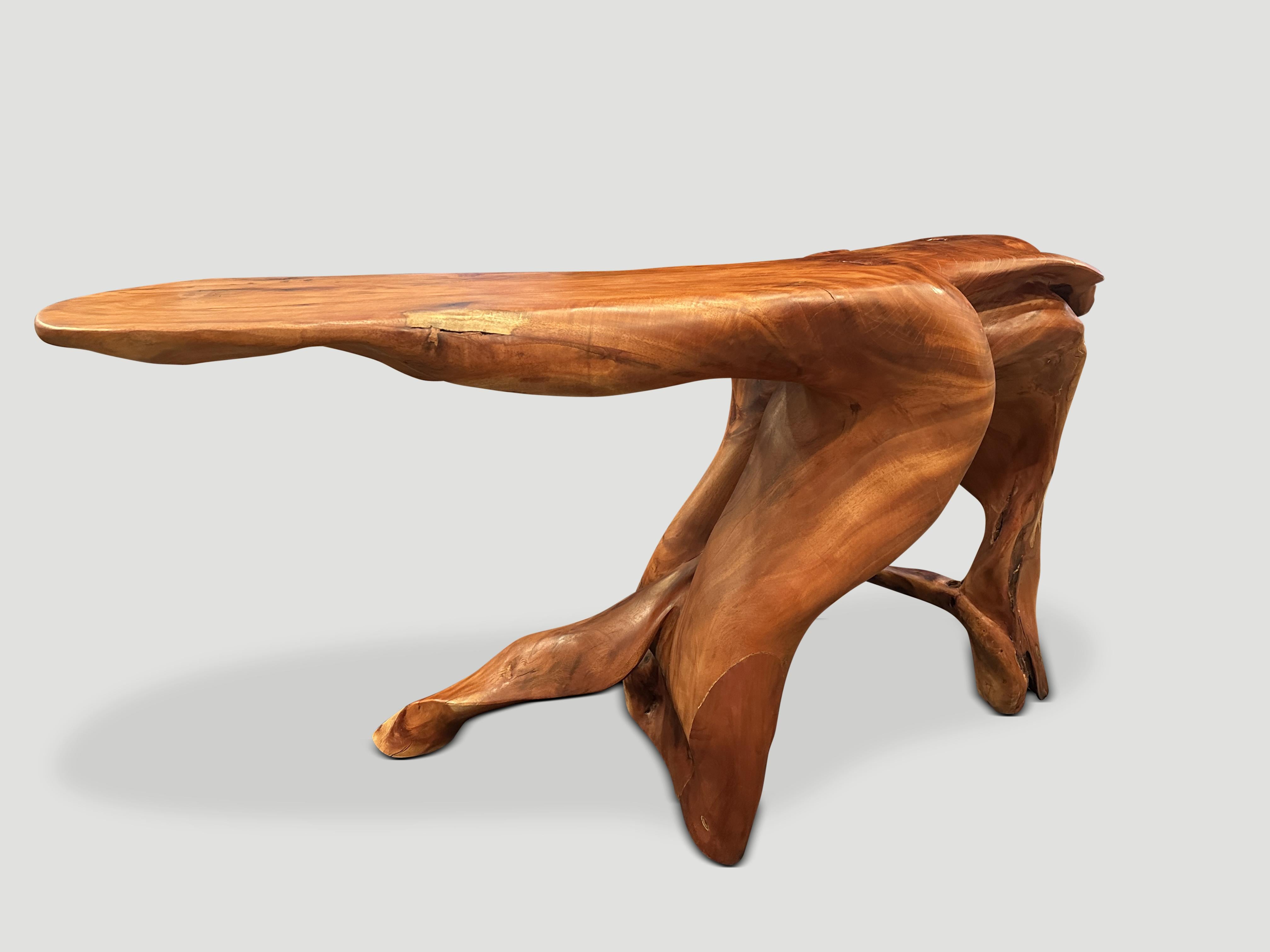 Beautiful reclaimed mahogany wood console table hand carved from a single root. Both sculptural and usable this one of a kind piece is stunning on both sides. We added a natural oil to reveal the impressive wood grain. It’s all in the details. 

Own