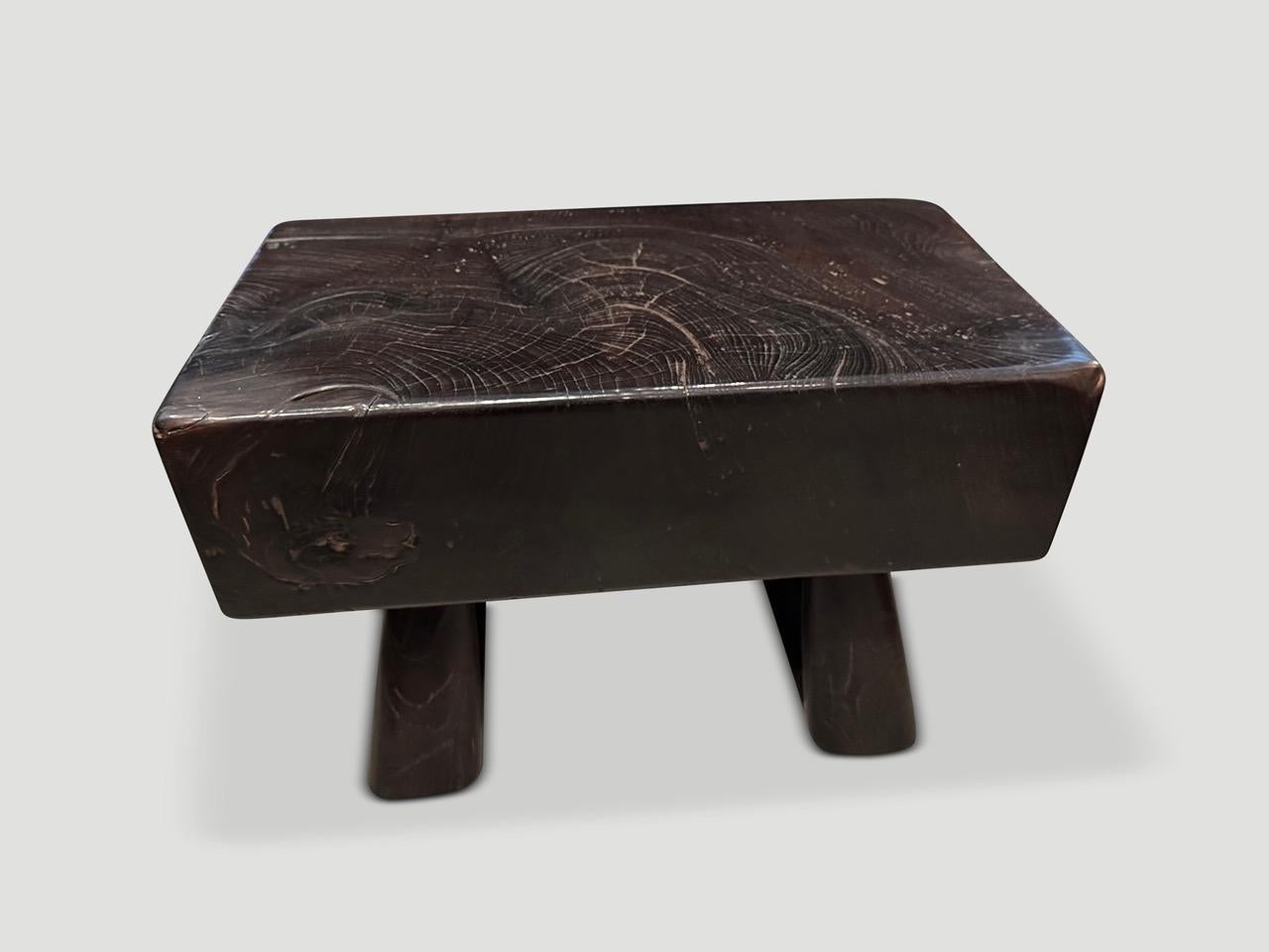 Part of the Mid Century Couture Collection, this one of a kind small bench or side table, has been handmade from a remarkable century old log taken from my finest collection. We added minimalist legs that allow the top to float nine inches off the