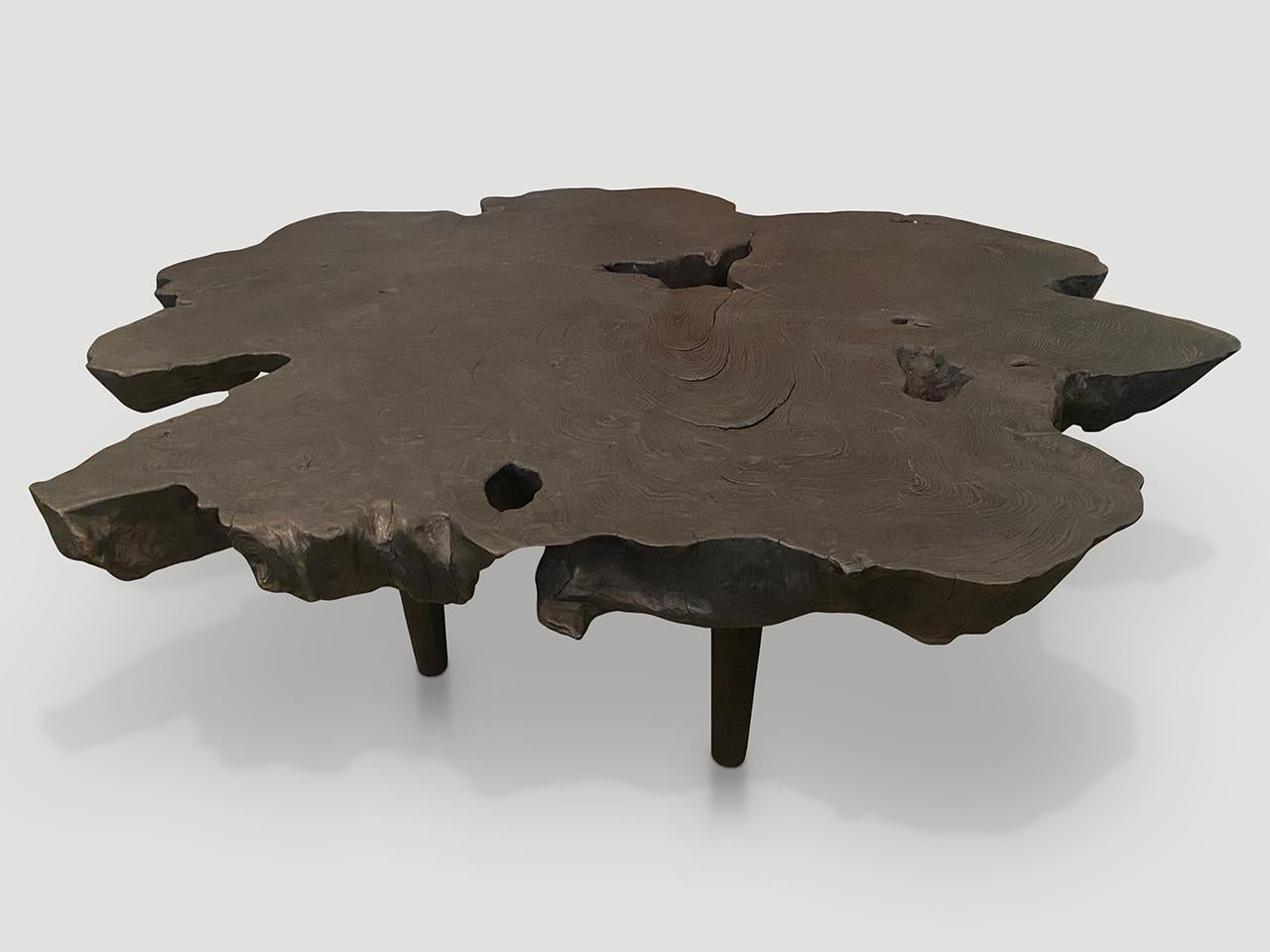 Beautiful natural shape on this three inch reclaimed teak wood coffee table. Floating on minimalist cylinder legs with a natural oil finish revealing the beautiful wood grain. Organic with a twist.

The Triple Burnt Collection represents a unique