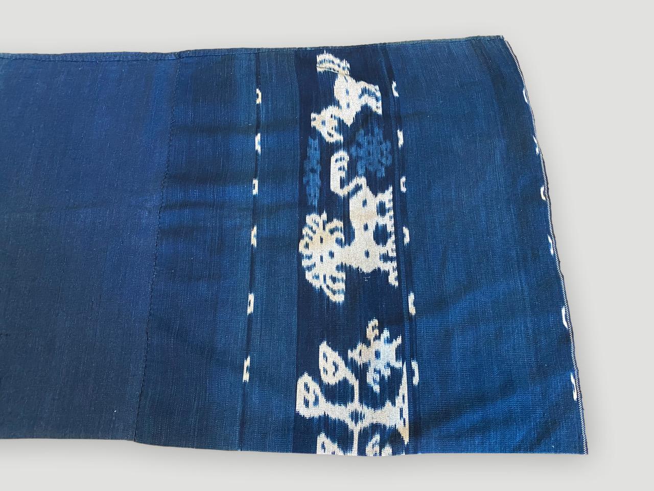 Lau are the tubular skirts worn by women. The same symbols that appear on a man’s hinggi reappear on the women’s skirts, but the range of techniques used often extend beyond ikat alone. 

On the one side the weave is more faded as shown in last few