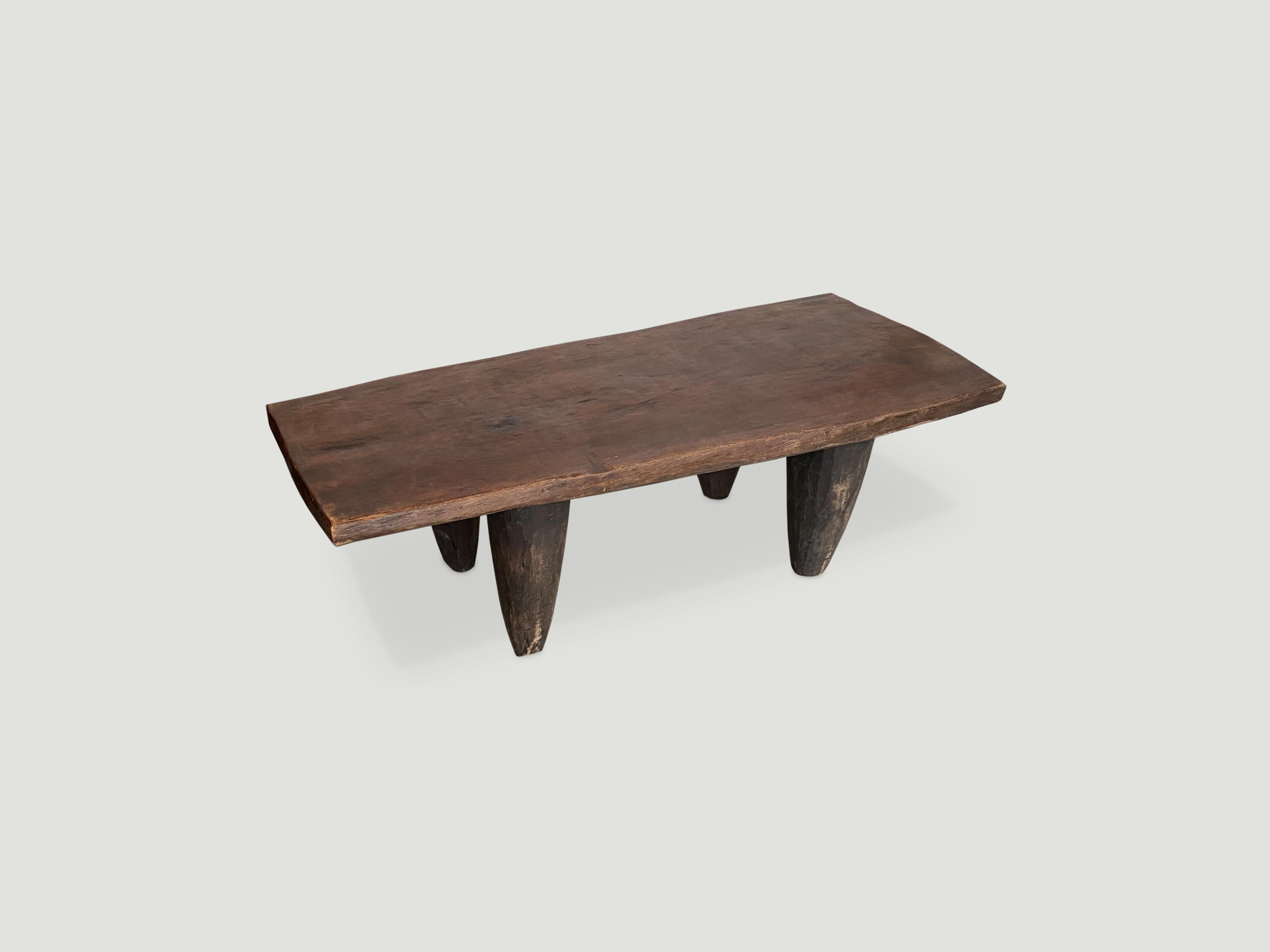 Antique bench or coffee table carved from a single piece of iroko wood, native to the west coast of Africa. The wood is tough, dense and very durable. Shown with cone style legs.

This bench or coffee table was sourced in the spirit of wabi-sabi,