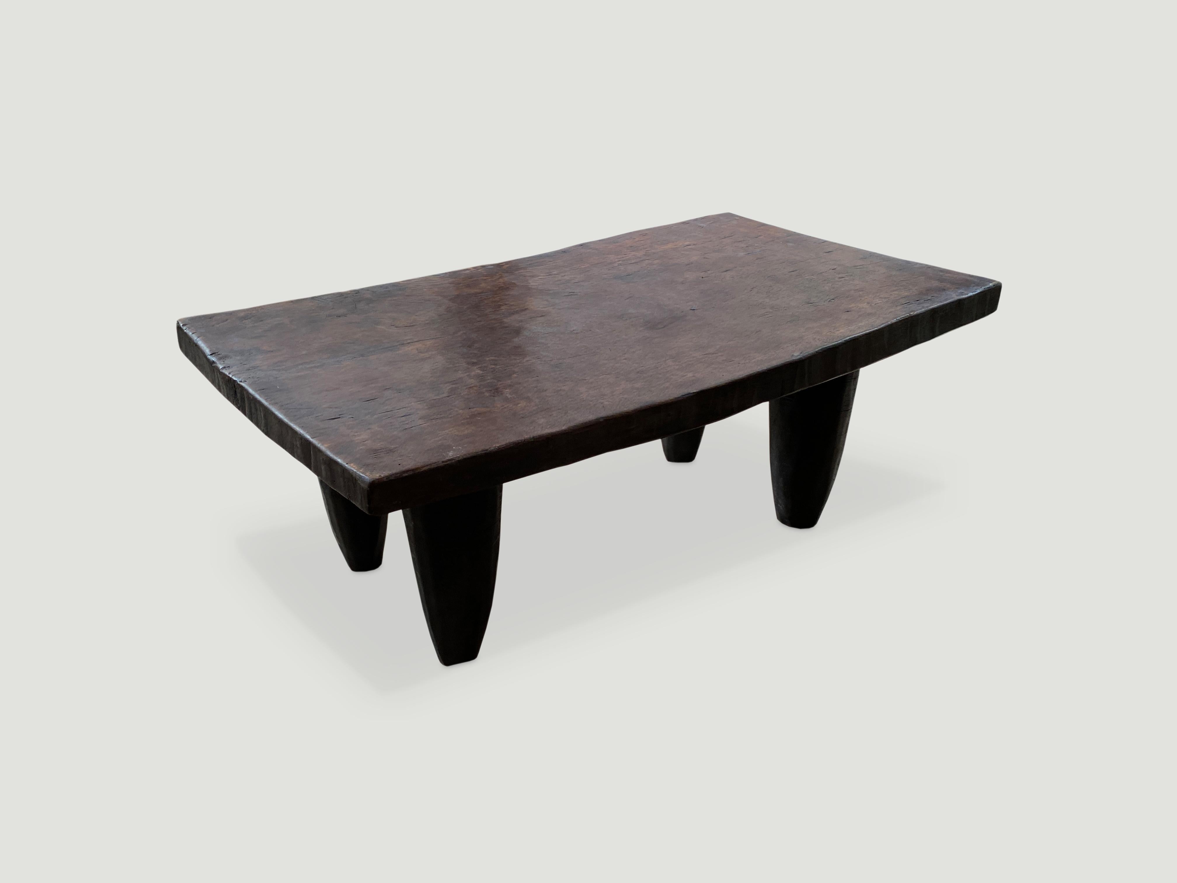 Antique bench or coffee table carved from a single piece of iroko wood, native to the west coast of Africa. The wood is tough, dense and very durable. Shown with cone style legs. 2