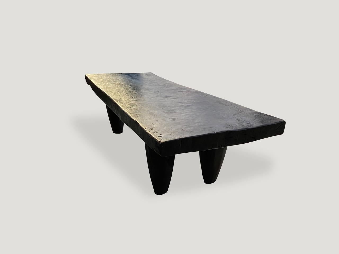 Antique bench or coffee table hand carved by the Senufo tribes from a single piece of iroko wood, native to the west coast of Africa. The wood is tough, dense and very durable. Shown with cone style legs.

This bench or coffee table was sourced in