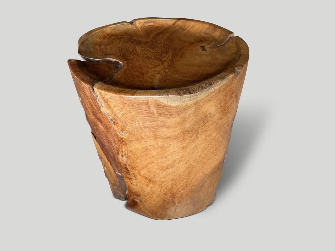 Beautiful century old teak root shaped into a side table. We hand carved the top section into a tray style and added the inlaid butterfly detail. Polished with a natural oil revealing the unique wood grain. Both usable and sculptural. We have a