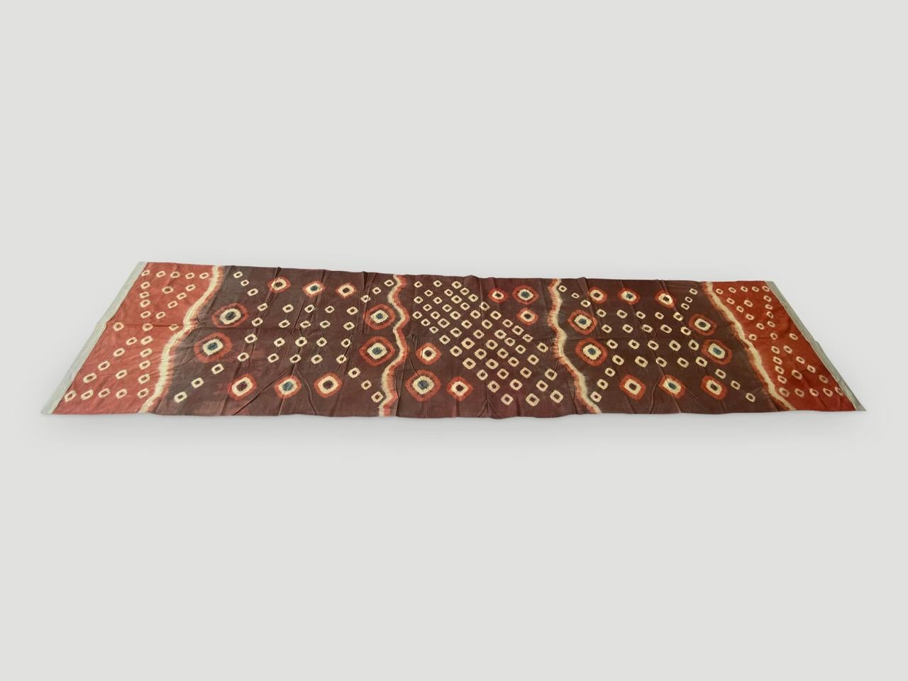 Striking ‘pelangi’ tie-dyed textile from Toraja Land, South Sulawesi. We added a linen border, double backed on both ends. This beautiful panel can be used as a wall hanging, draped over a bed or sofa or as a window panel. We have a collection. The