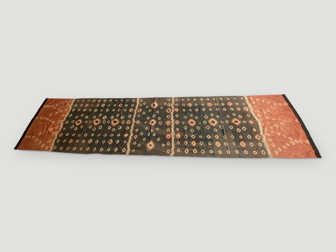 Striking ‘pelangi’ tie-dyed textile from Toraja Land, South Sulawesi. We added a linen border, double backed on both ends. This beautiful panel can be used as a wall hanging, draped over a bed or sofa or as a window panel. We have a collection. The