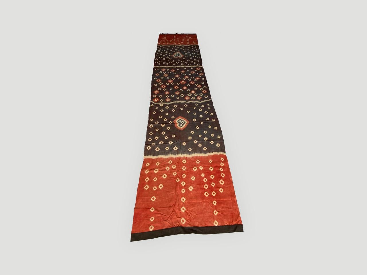 Striking “pelangi” tie-dyed textile from Toraja Land, South Sulawesi. We added a linen border, double backed on both ends. This beautiful panel can be used as a wall hanging, draped over a bed or sofa or as a window panel. We have a collection. The