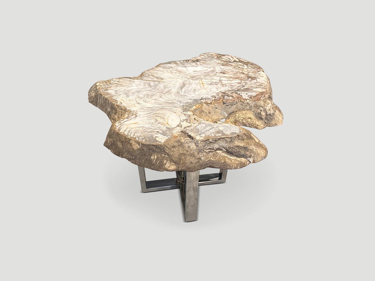 Beautiful neutral tones in this high quality petrified wood two inch slab side table. Shown with a choice of a minimalist stainless steel base or a black metal coated base. It’s fascinating how Mother Nature produces these exquisite 40 million year