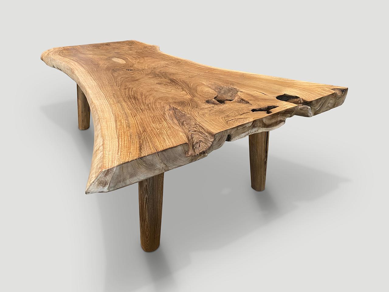 Impressive reclaimed teak wood live edge single slab coffee table. We added minimalist cylinder legs. Finished in a natural oil revealing the beautiful wood grain.

Own an Andrianna Shamaris original.

Andrianna Shamaris. The Leader In Modern