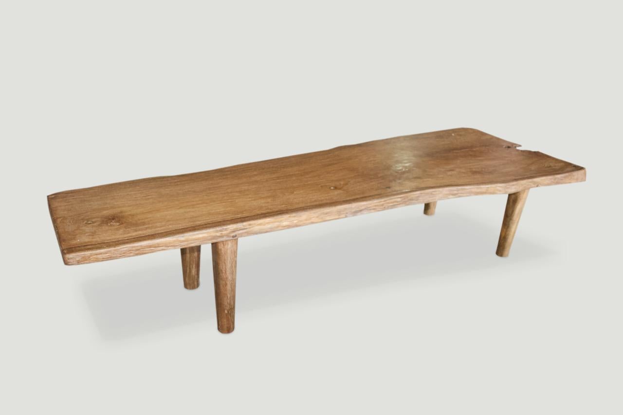 Impressive live edge reclaimed teak wood coffee table or bench. Stunning grain in this single two and a half inch thick slab with a natural oil finish. We added the midcentury style legs and can also increase the height for a console or dining